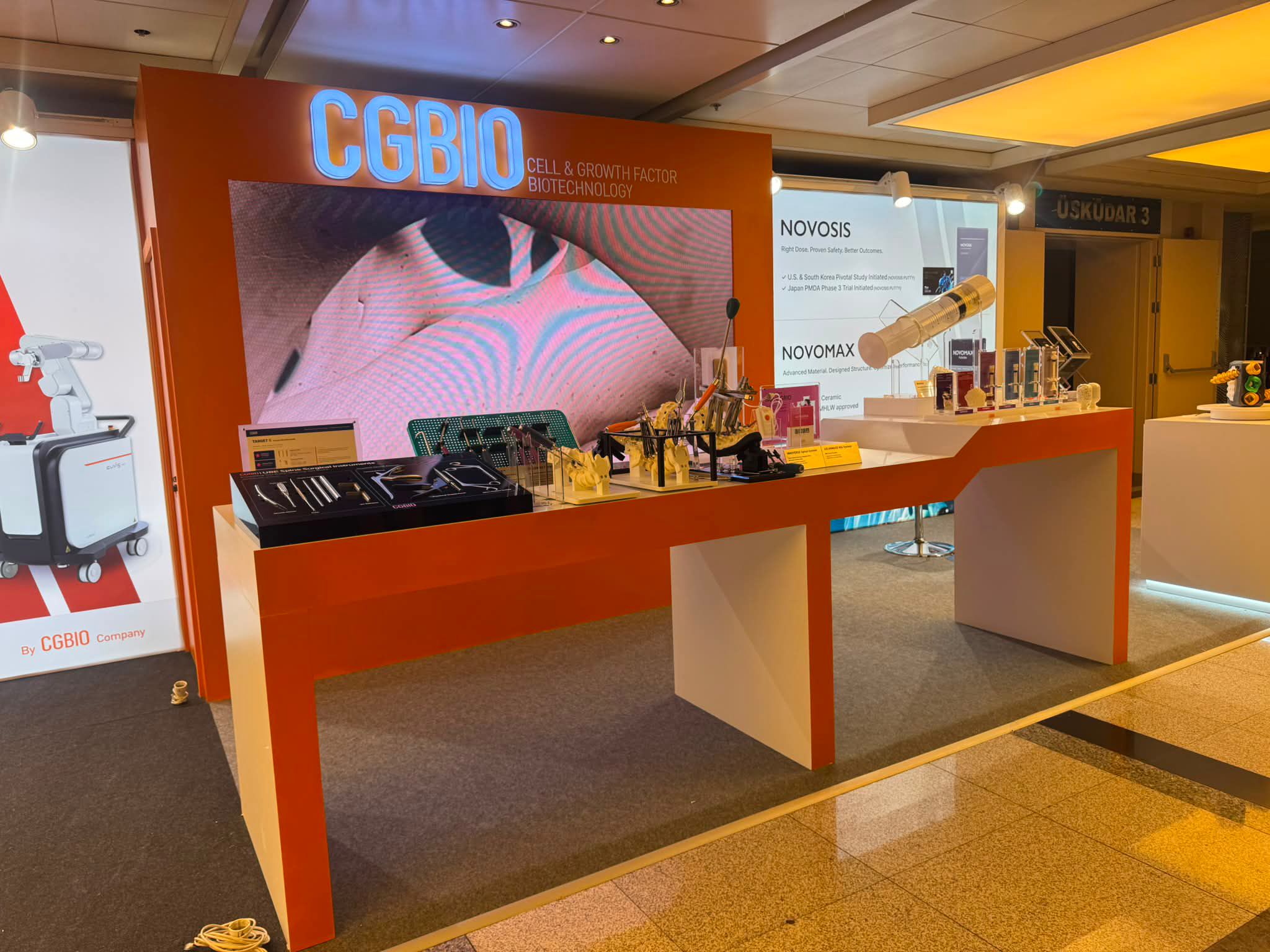 Product display counters at the CGBIO stand showing medical instruments, implant models, and spine-related tools.