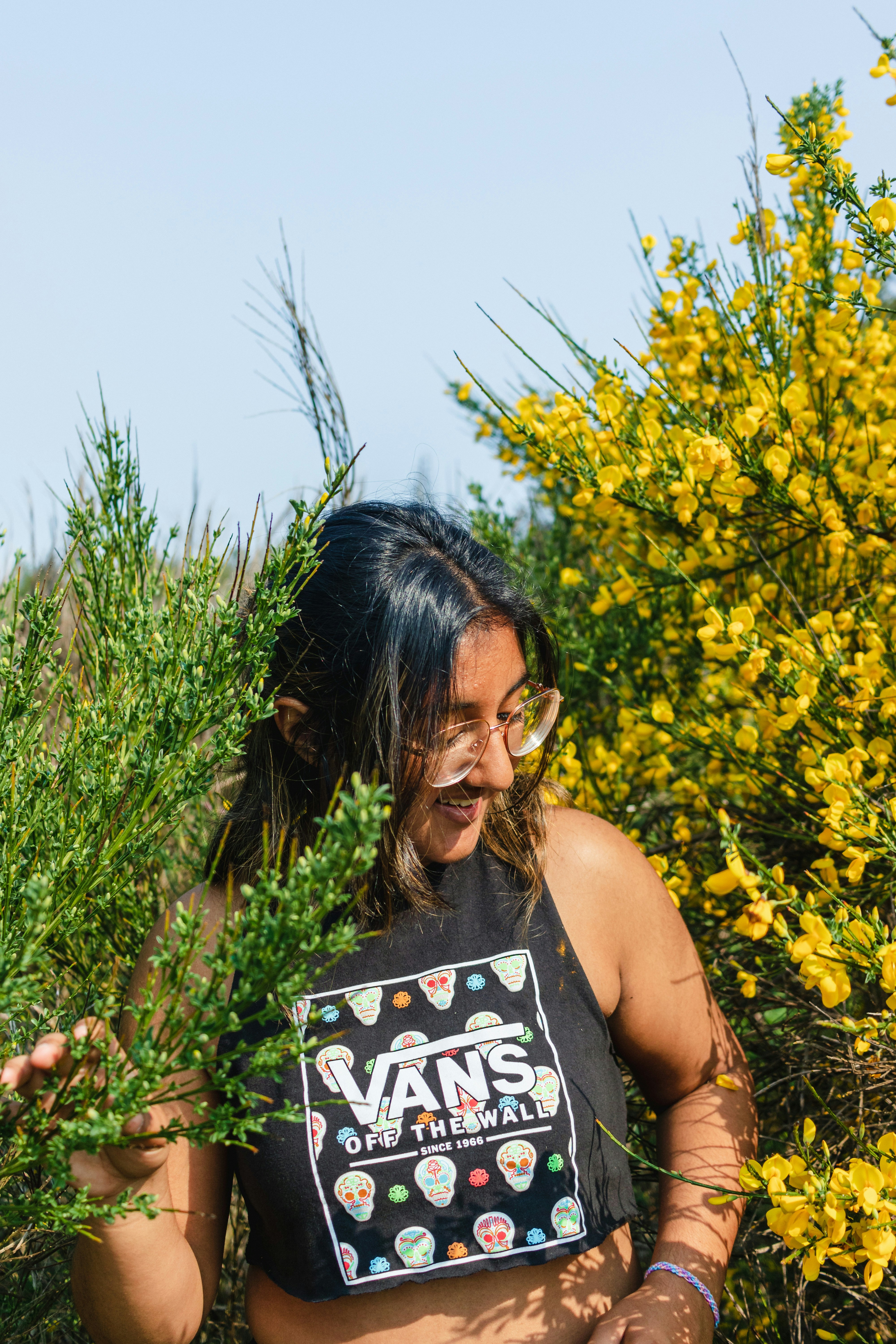a woman in a black shirt is holding a plant
