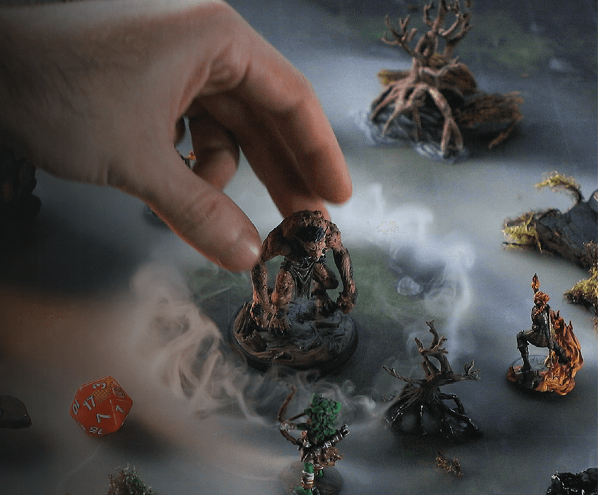 A person fingers reaching out to a miniature of an Troll