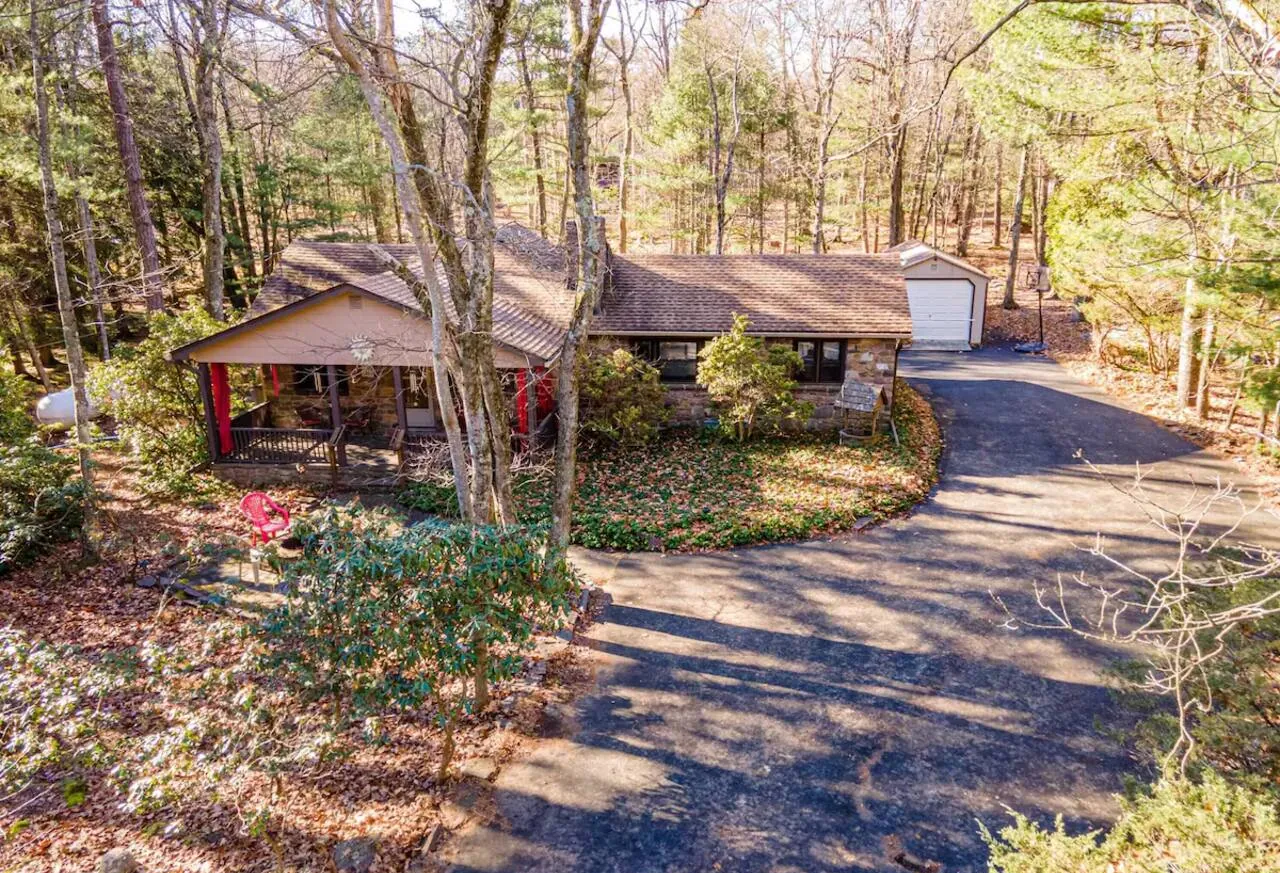 Elevated view of the ranch home, garage and curved driveway at Relax in Style, Lake Harmony, PA