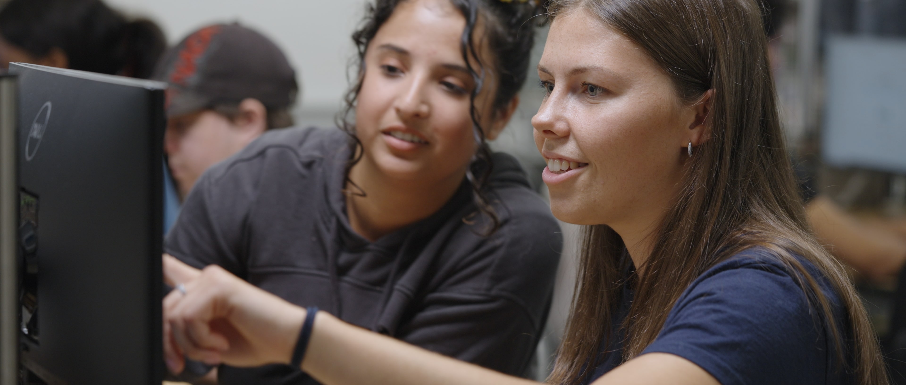 Front cover image for a short film made for Siemens depicting two ladies in front of a compueter pointing towards the screen