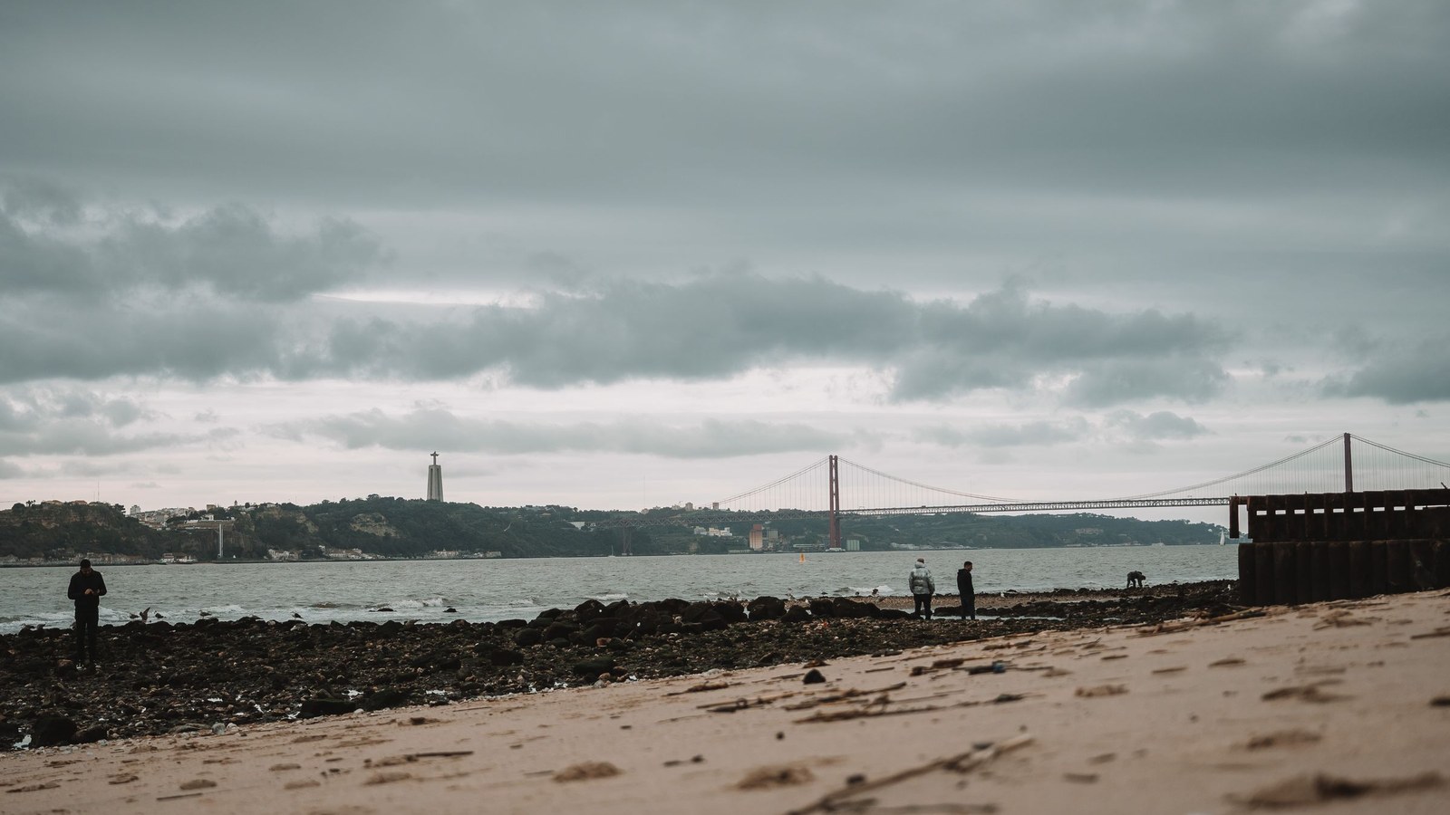 Beach near Lisbon beneath dramatic coastal clouds