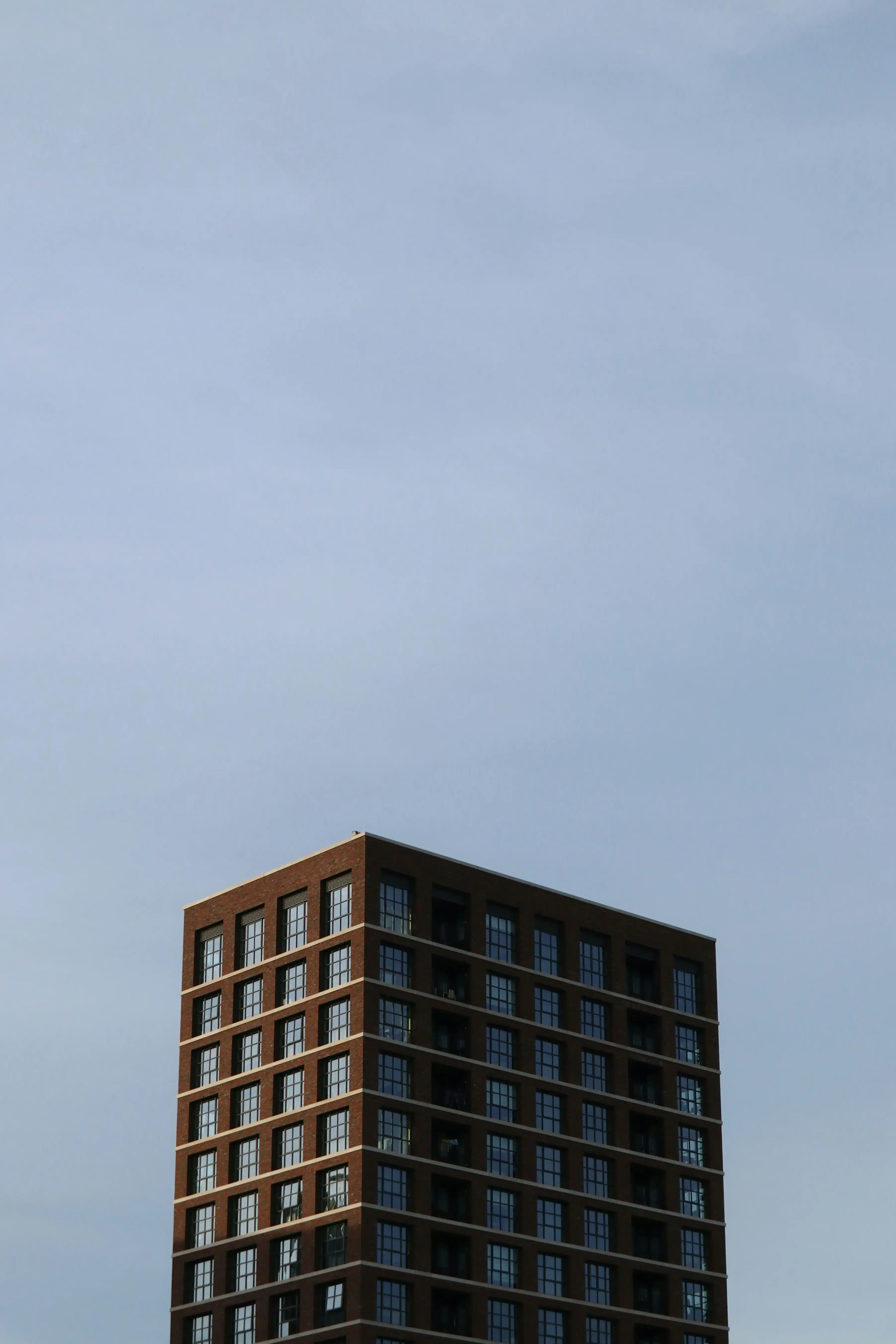 white concrete building with blue window