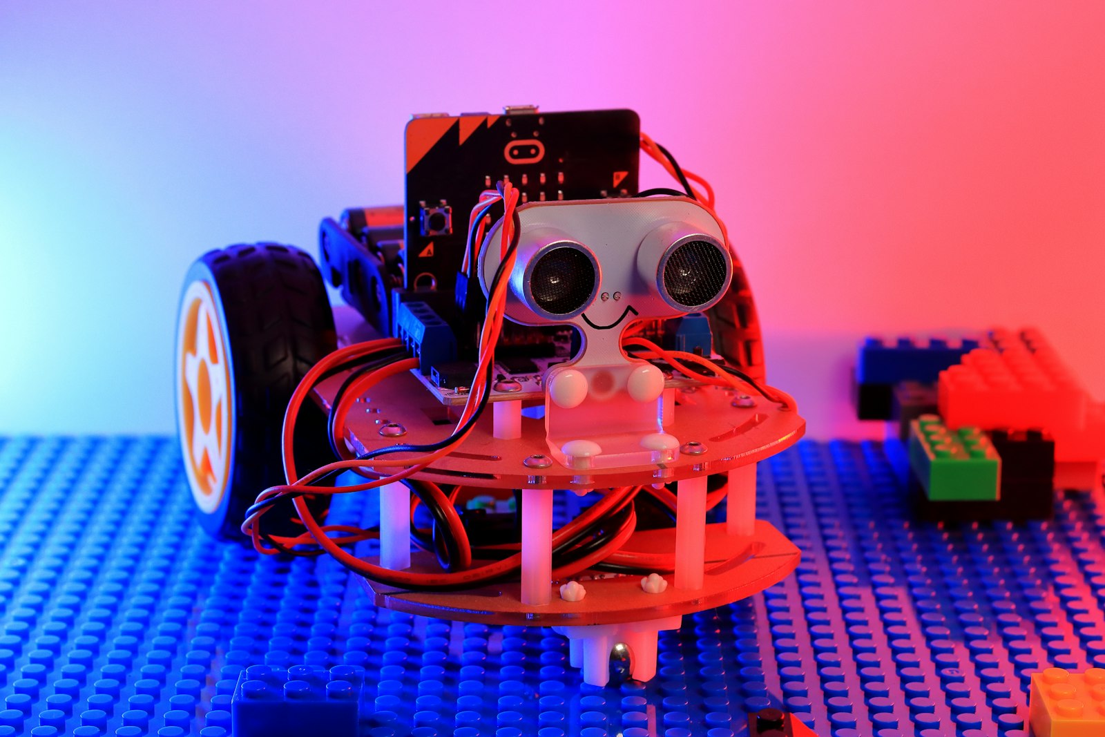 A small robot with a distance sensor on a brick baseplate