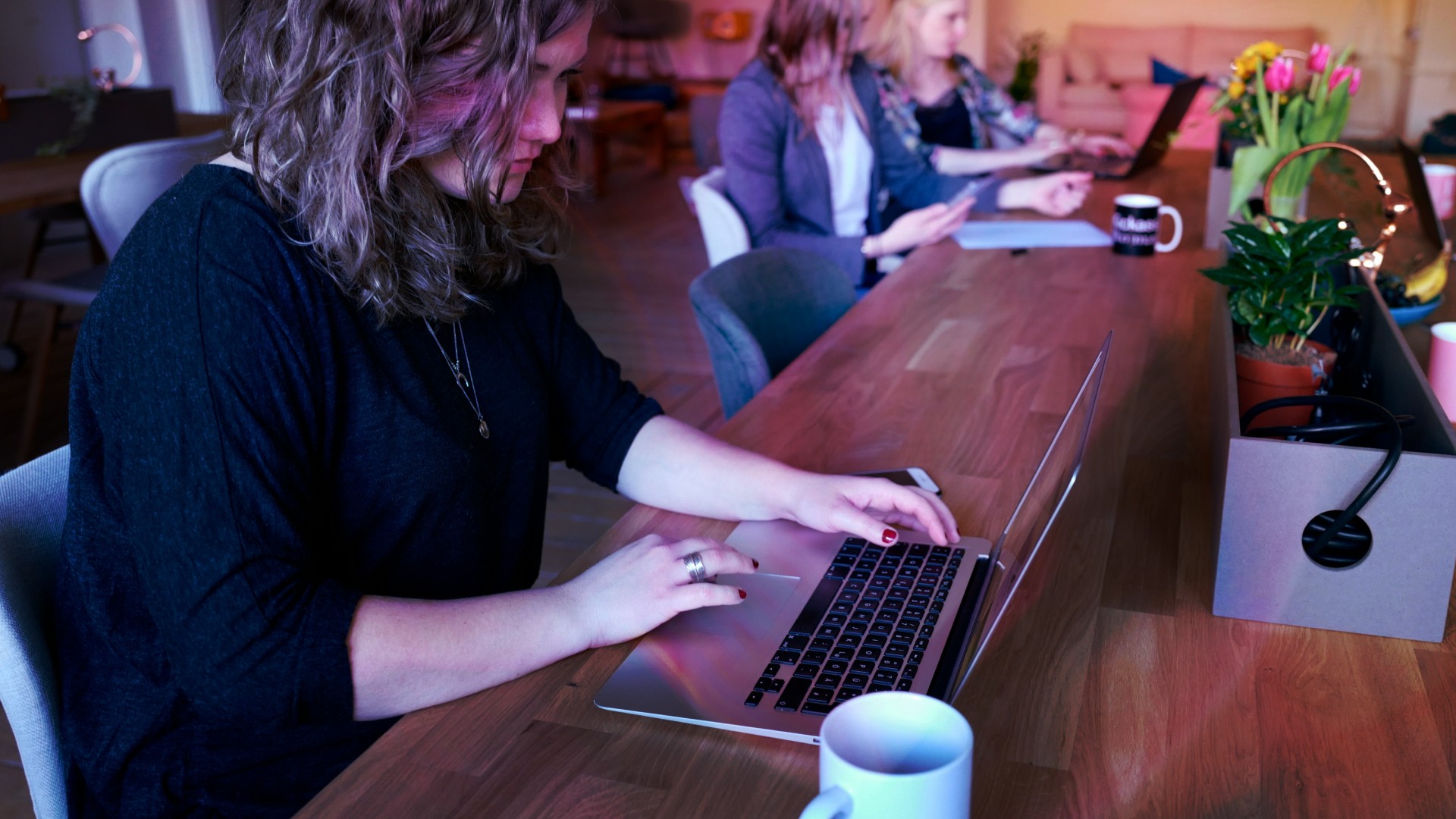 A woman looks intently at her laptop
