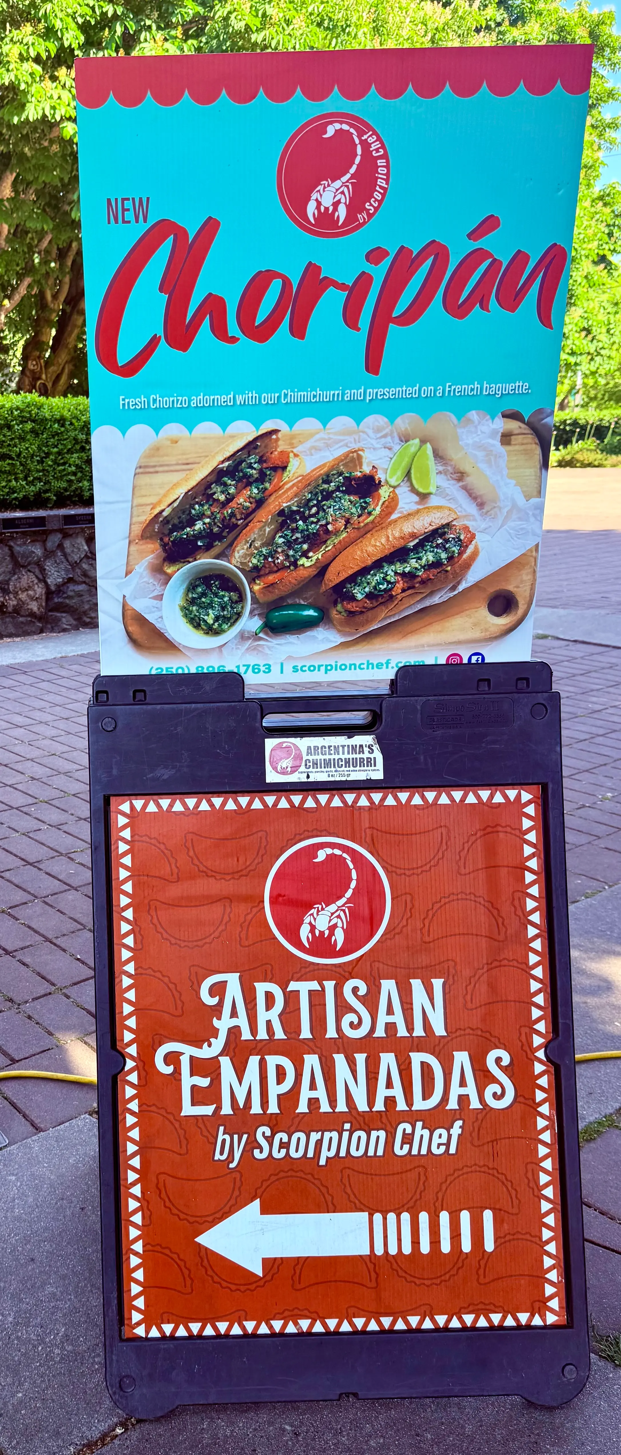 Scorpion Chef new choripán and artisan empanadas sandwich board sign at Vancouver Island farmer's market BC