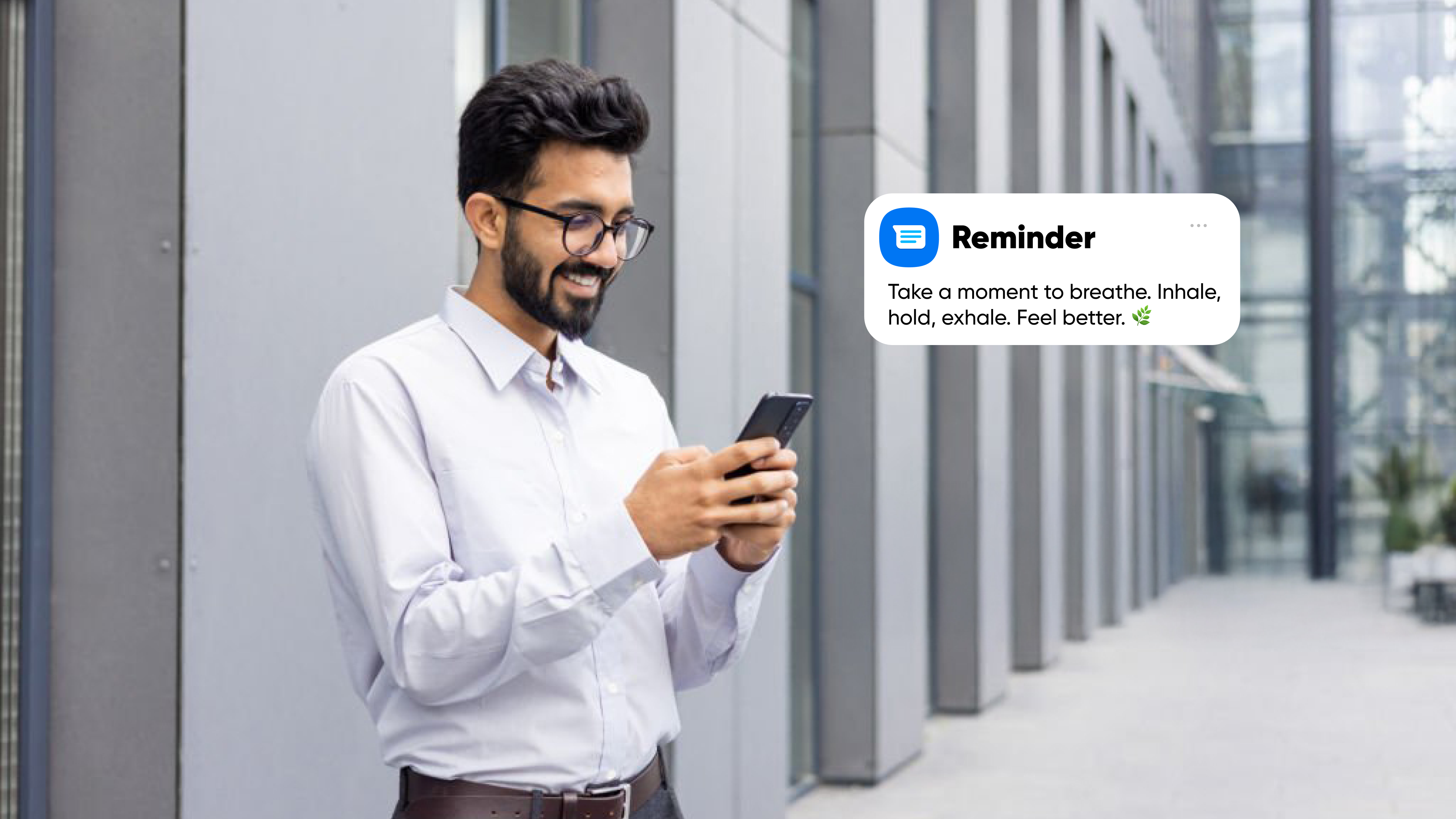 Professional man outdoors reading a wellness reminder on his phone, encouraging mindful breathing and mental relaxation during a busy workday. Self-care routine, Mental health tips, Stress management, Work-life balance, Personal wellness, Healthy lifestyle, Daily rituals, Build better habits, Self-care ideas for mental health