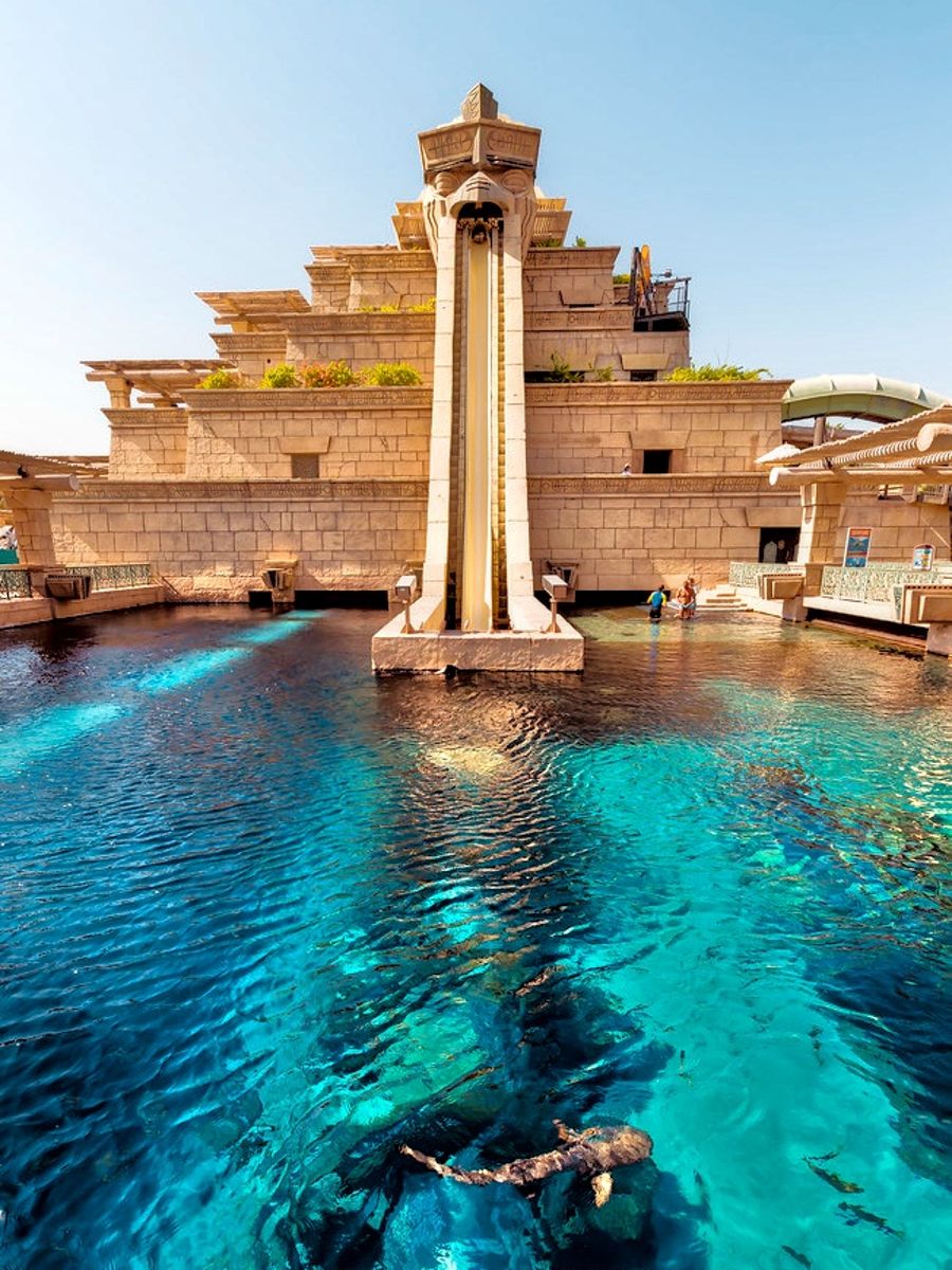 three brown wooden boat on blue lake water taken at daytime