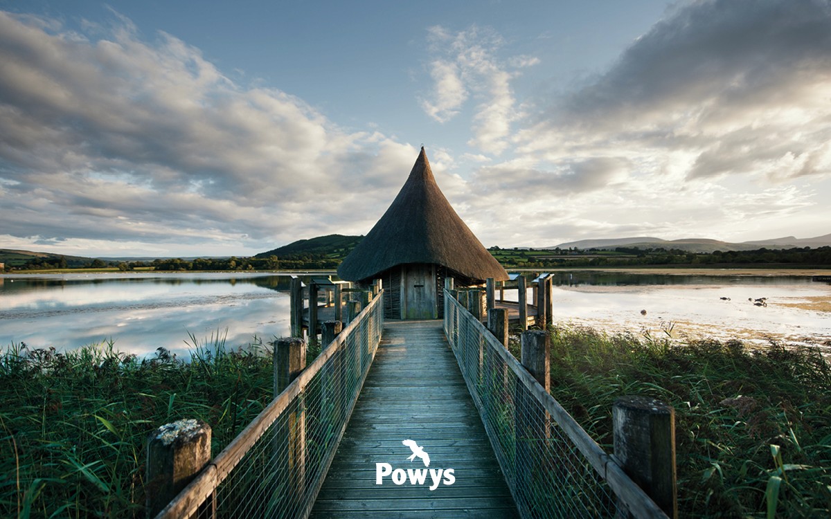 Photo of a hut at the edge of a lake