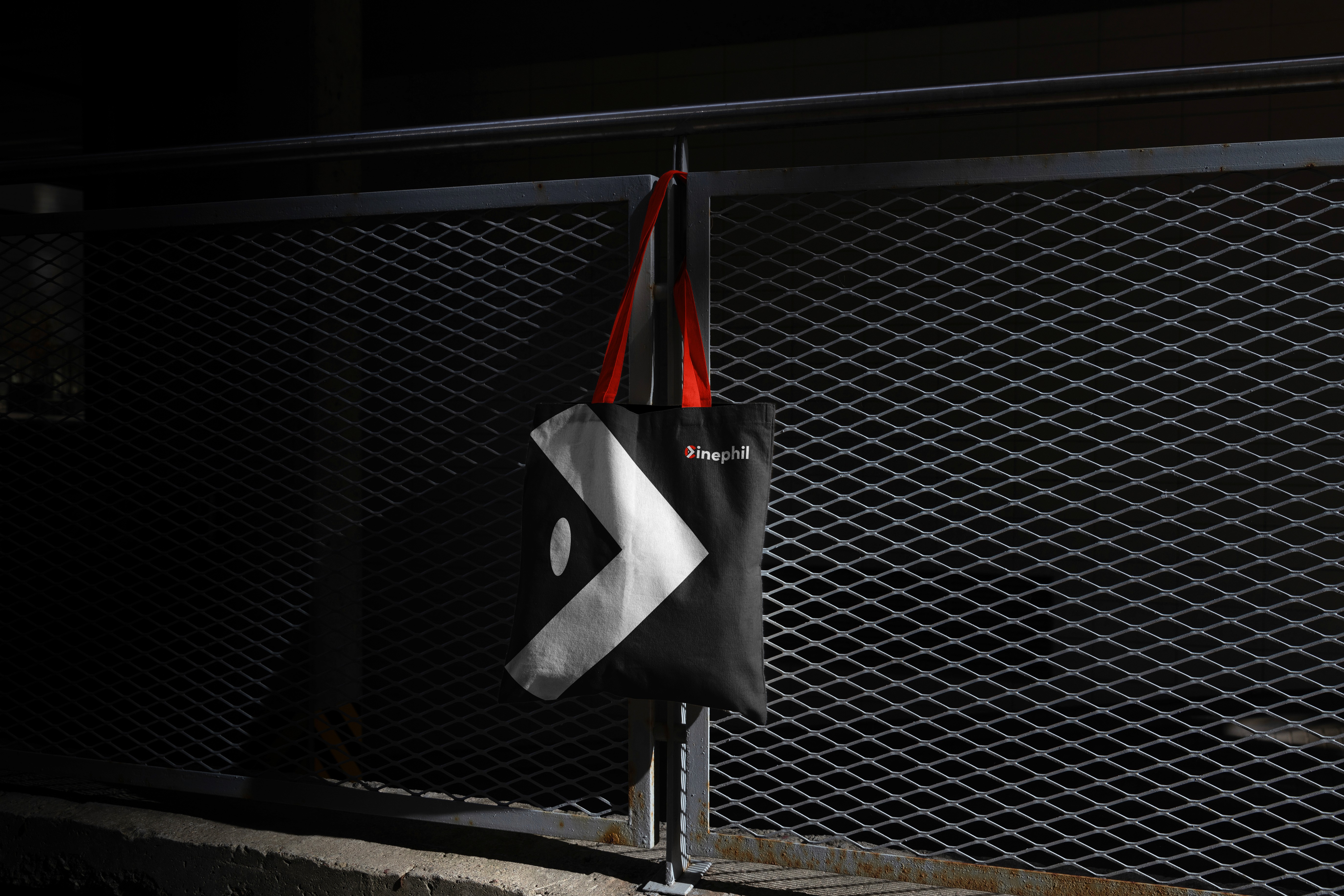 Three slim, upright orange packaging boxes side by side, each showing a partial black smiley face and “Smiley Co” text on the top, with a matching orange background.