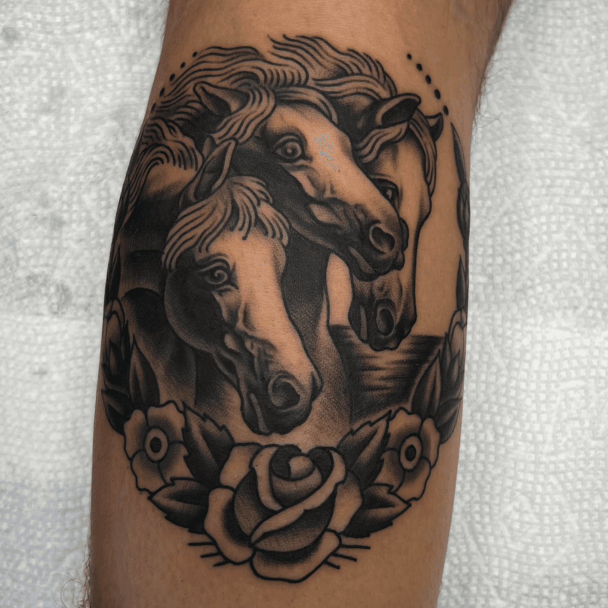 black and gray tattoo of pharoah's horses and roses