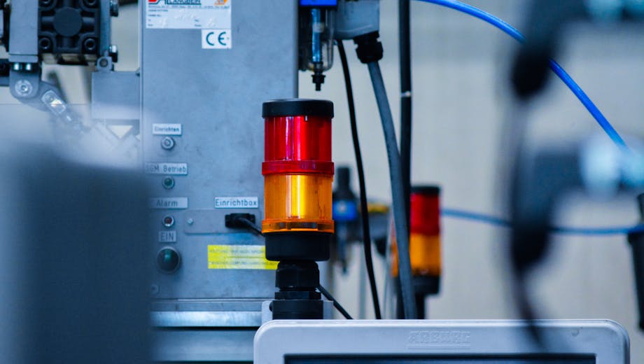 Detailed view of automated machinery with warning signals in an industrial setting.