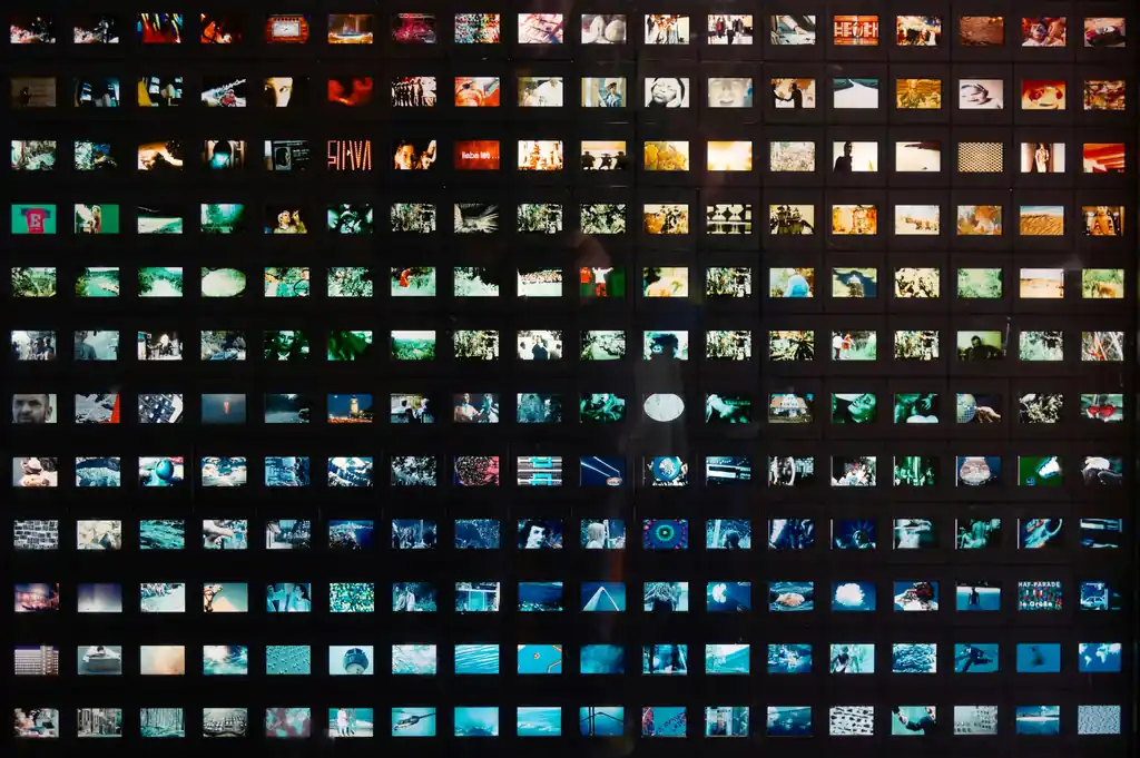 a black wall with a lot of different pictures on it