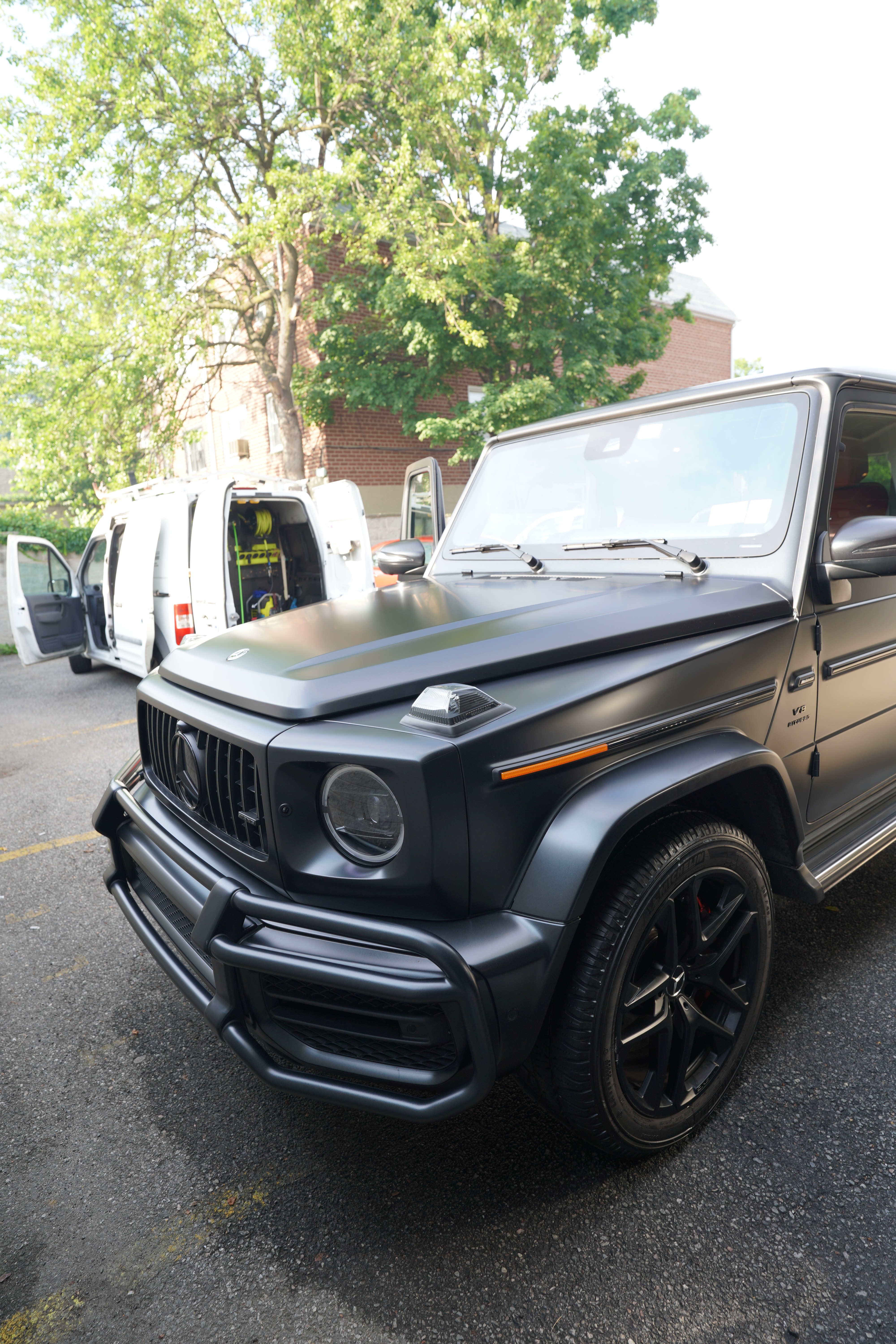 Mobile ceramic coating service NYC - XENTRA AUTO technician applying 9H ceramic coating