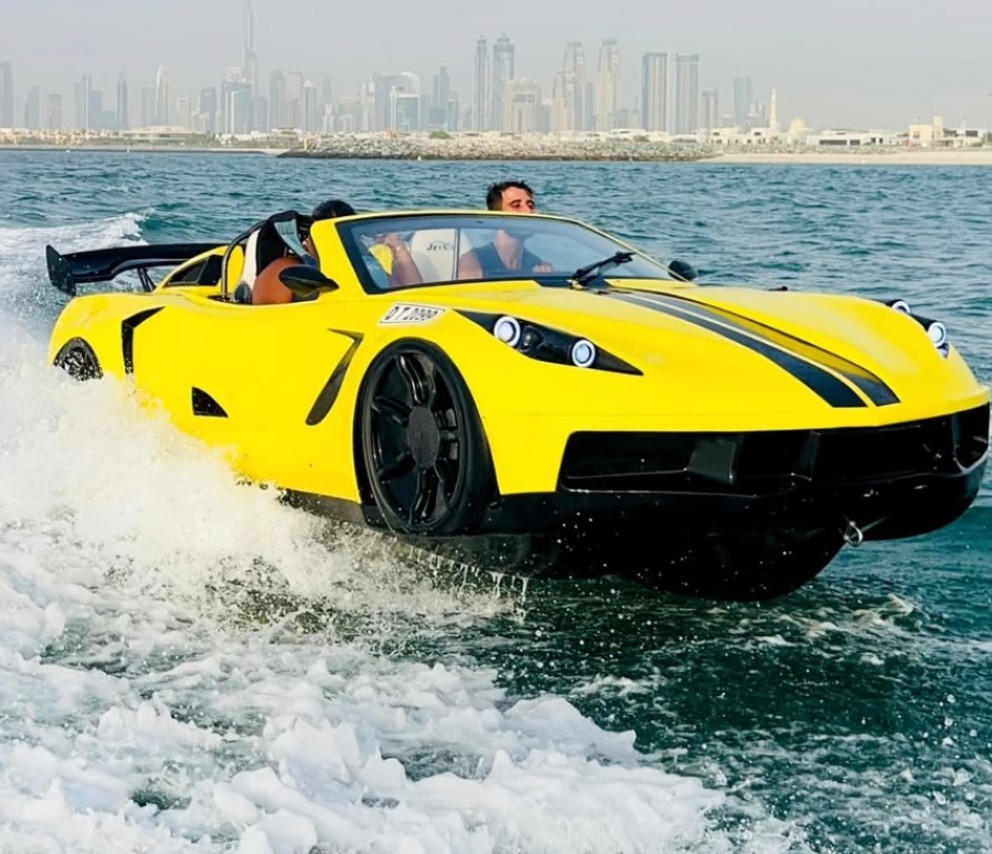 A water car zooms through the ocean waters with two people on board. 