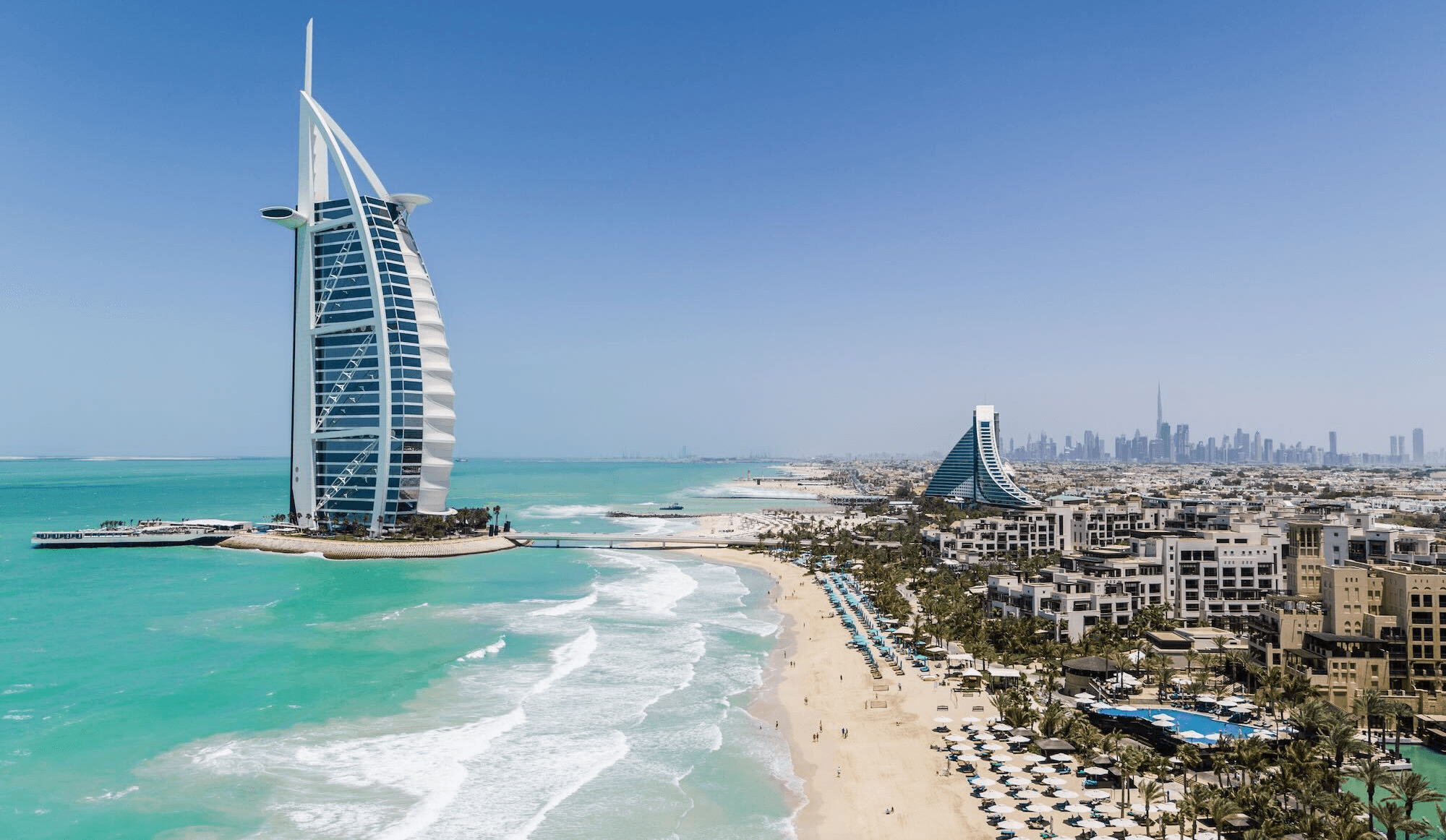 The Burj Al Arab and Jumeirah Beach in Dubai with several commercial areas and spaces located along the shoreline.