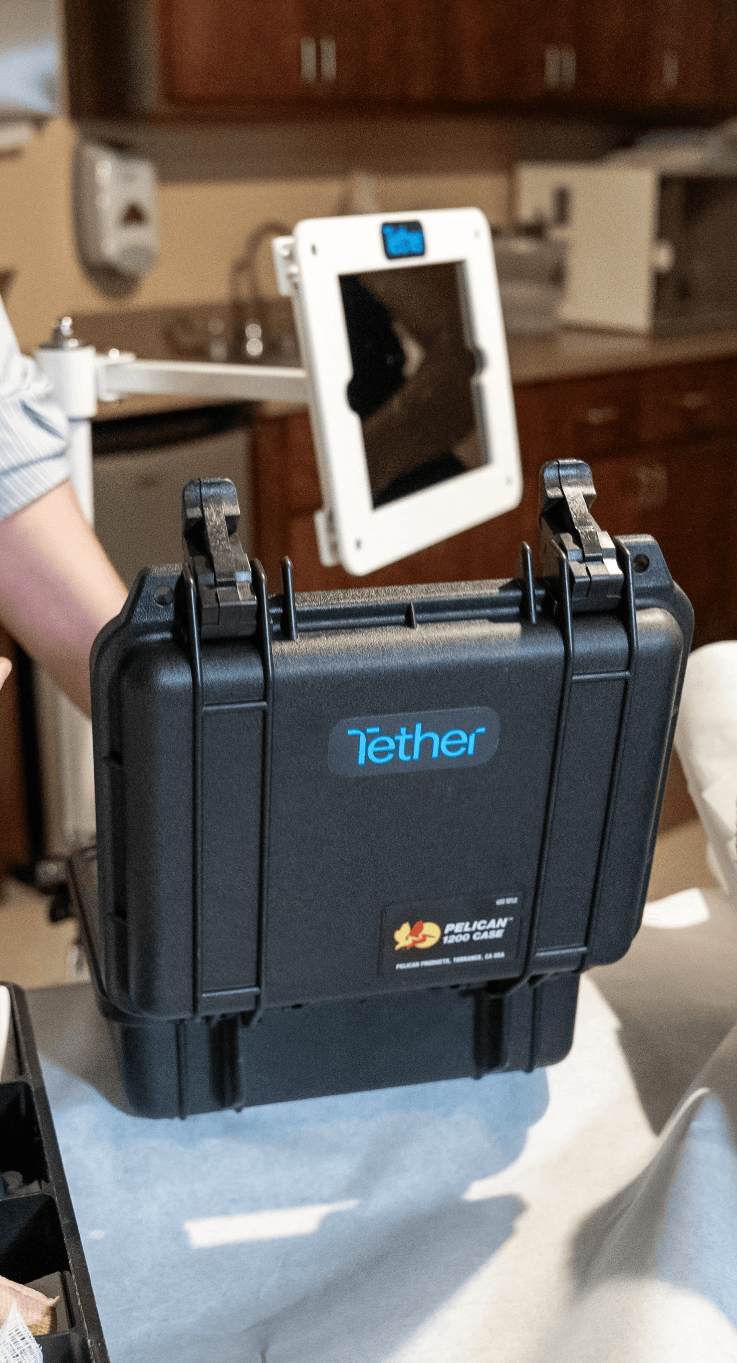 Tether Supervision mobile contrast unit displaying a live virtual radiologist on a HIPAA-compliant video platform, providing real-time precision guidance and scalable virtual direct supervision for contrast-enhanced CT and MRI in outpatient imaging centers.