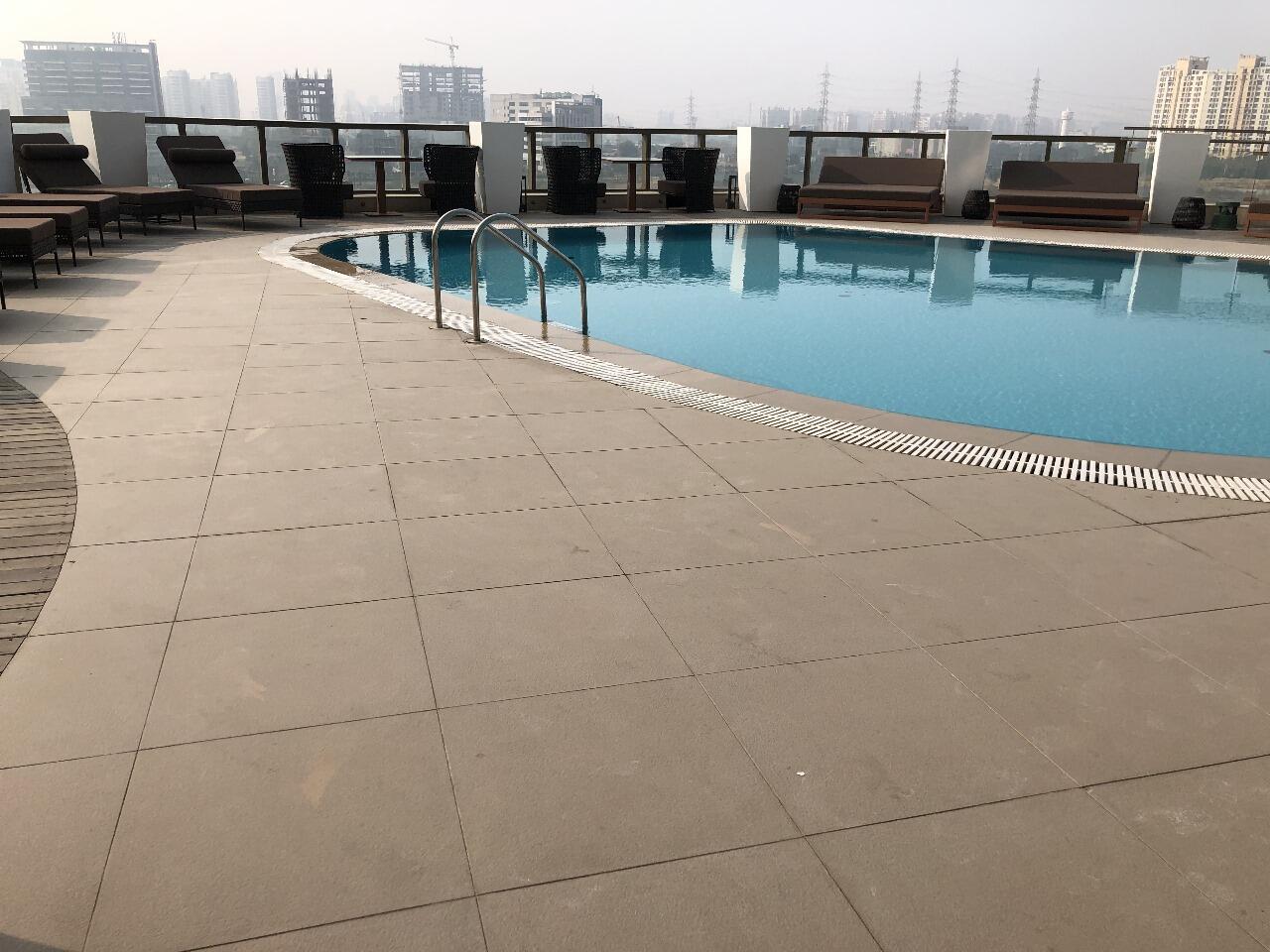 Rooftop swimming pool with skyline view in Sector 65, Gurugram