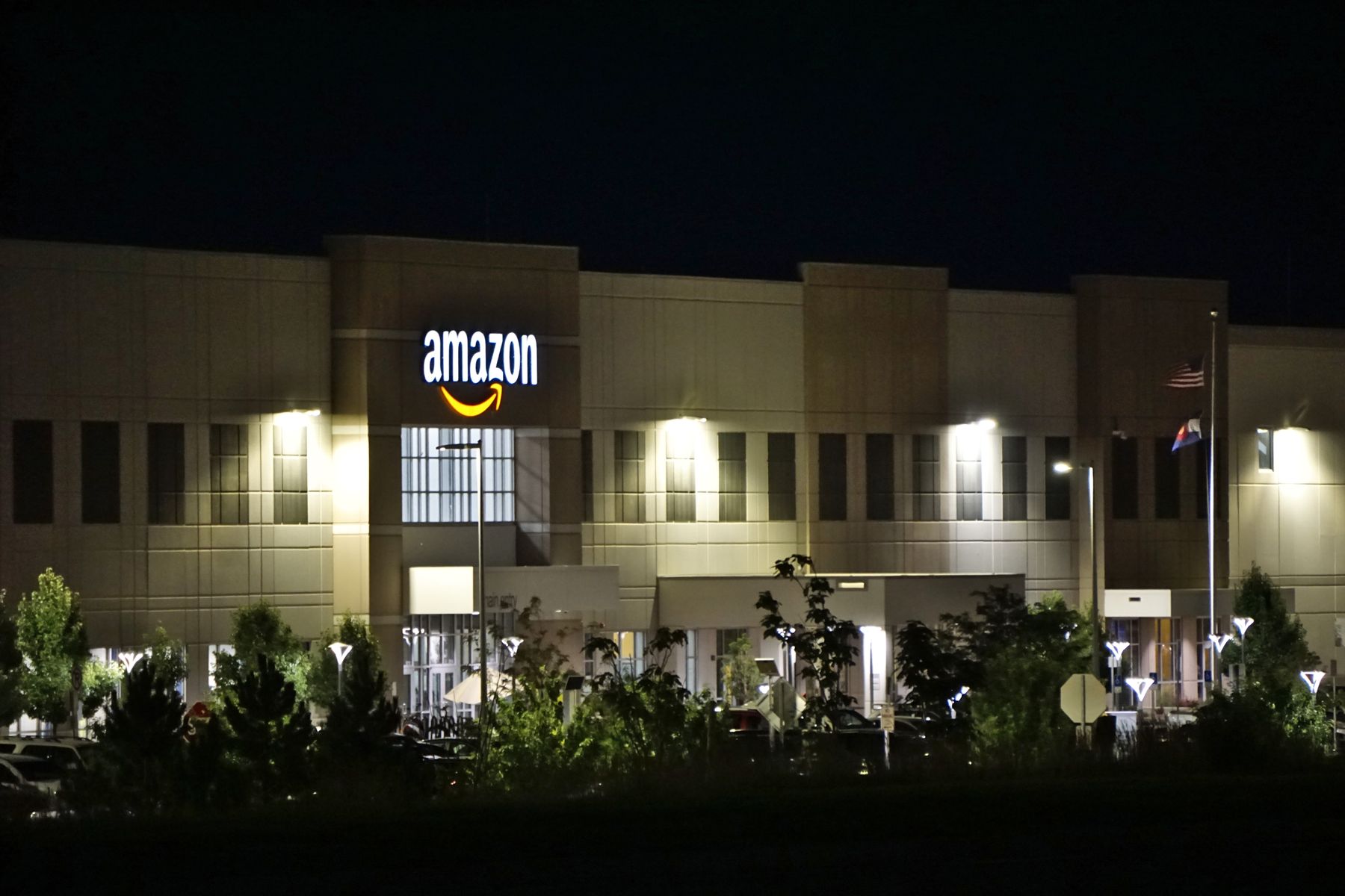 Amazon facility illuminated at night