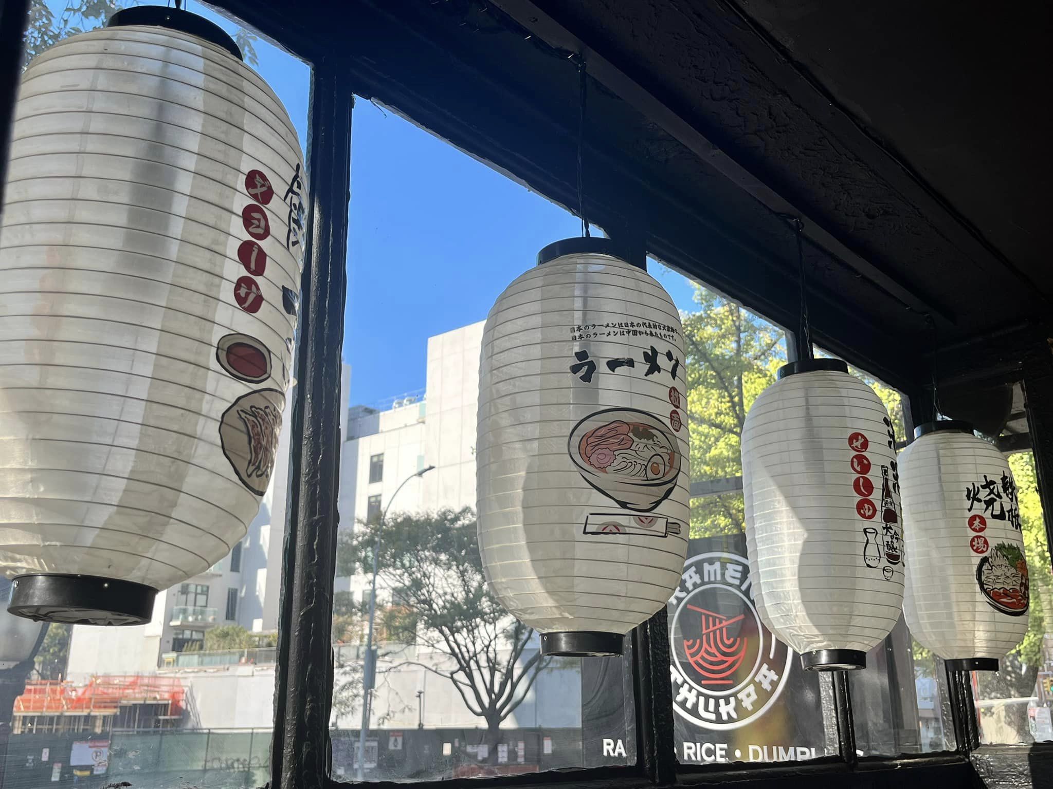 Ramen Thukpa Interior: The modern, spacious interior of Ramen Thukpa, featuring warm wooden accents, cozy lighting, and a bustling yet welcoming atmosphere. Perfect for enjoying a hearty bowl of ramen or sharing dumplings with friends.