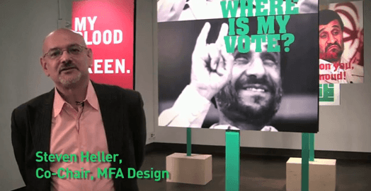 A photo of Steven Heller, Co Chair, MFA Design department, while standing near the Iranian satire exhibition.