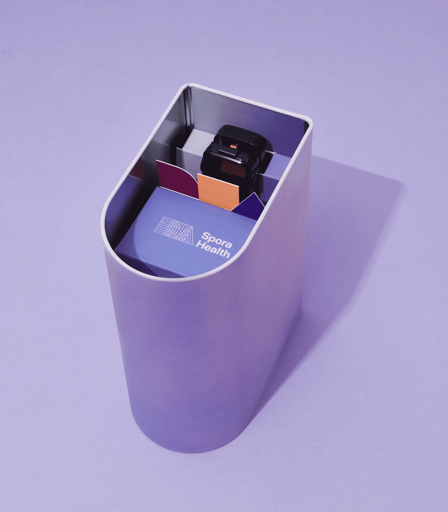 Spora Health Momma's Kit packaging and medical devices arranged in a purple case