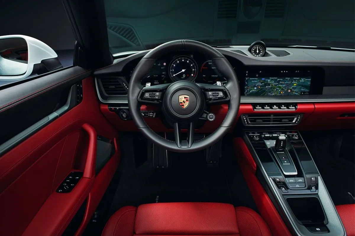 Luxury car interior with red leather and a digital dashboard