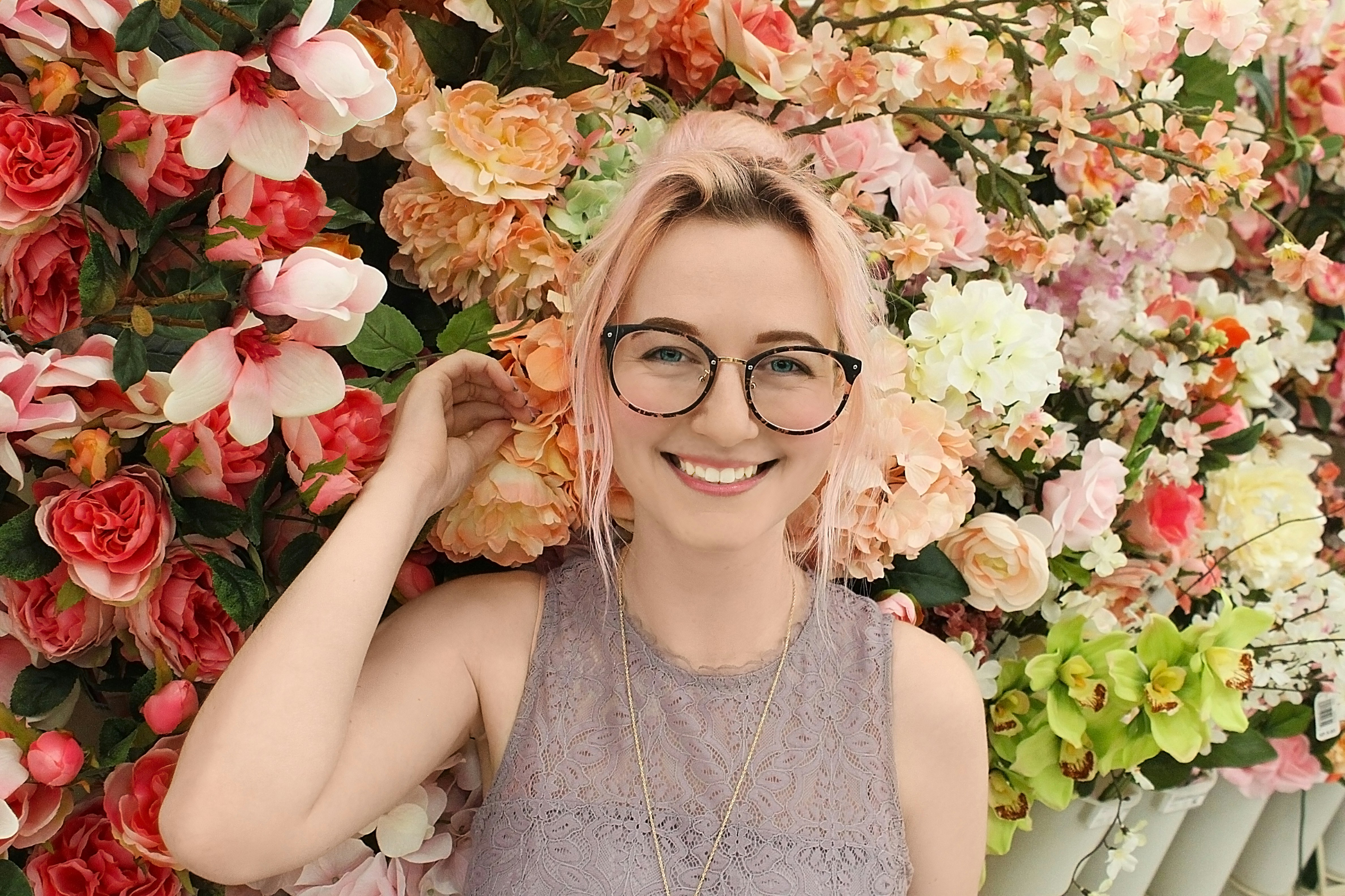 woman standinh infront of flowers - Clear Spring Color Analysis