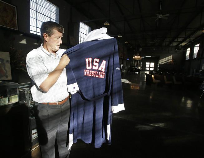 Rob Olson of Erkelens & Olson Auctioneers displays Rulon Gardner's...