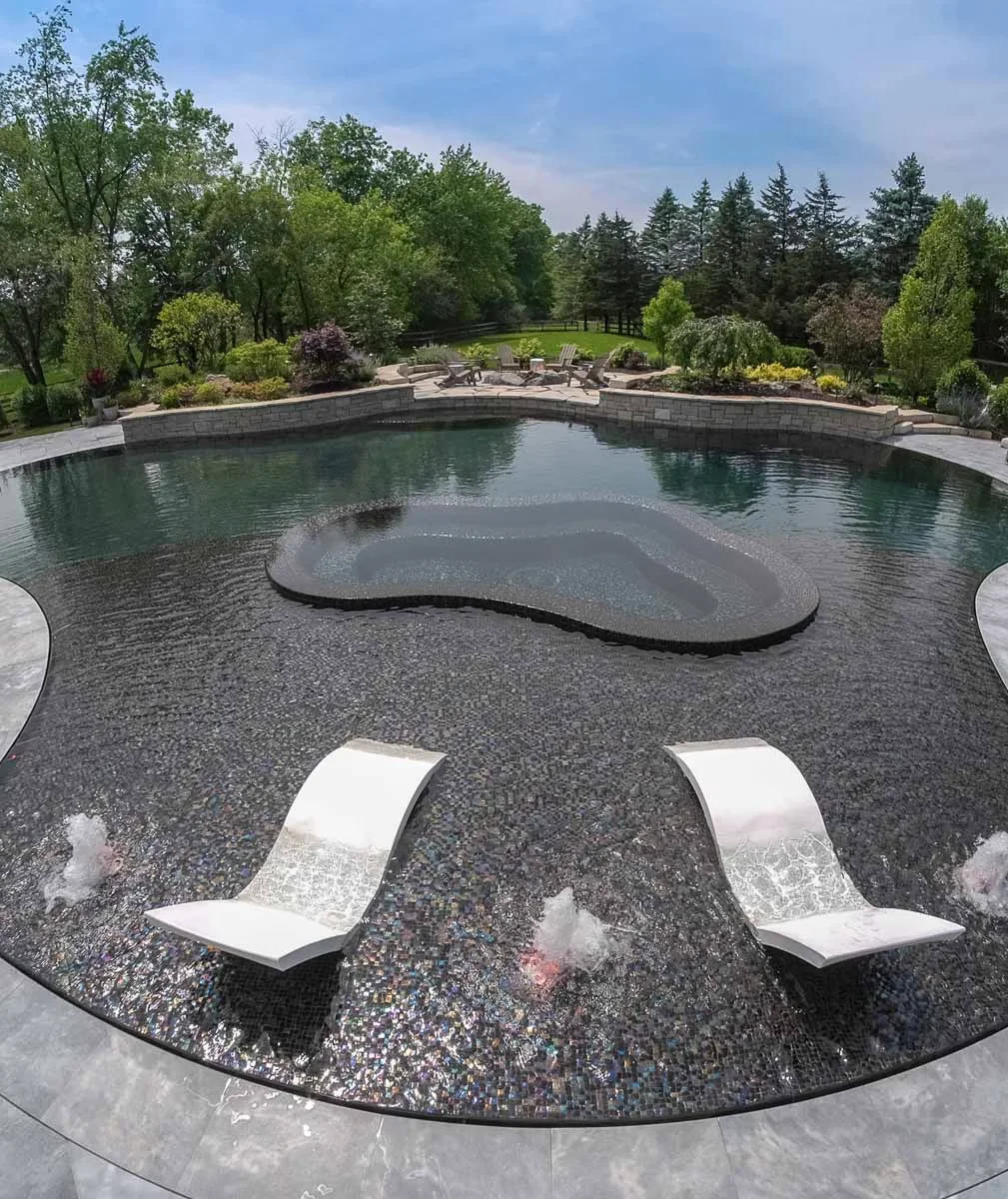Finished all-tile mosaic pool in Barrington Hills; individual glass tesserae visible on the shallow sun shelf, the deep end reading dark green