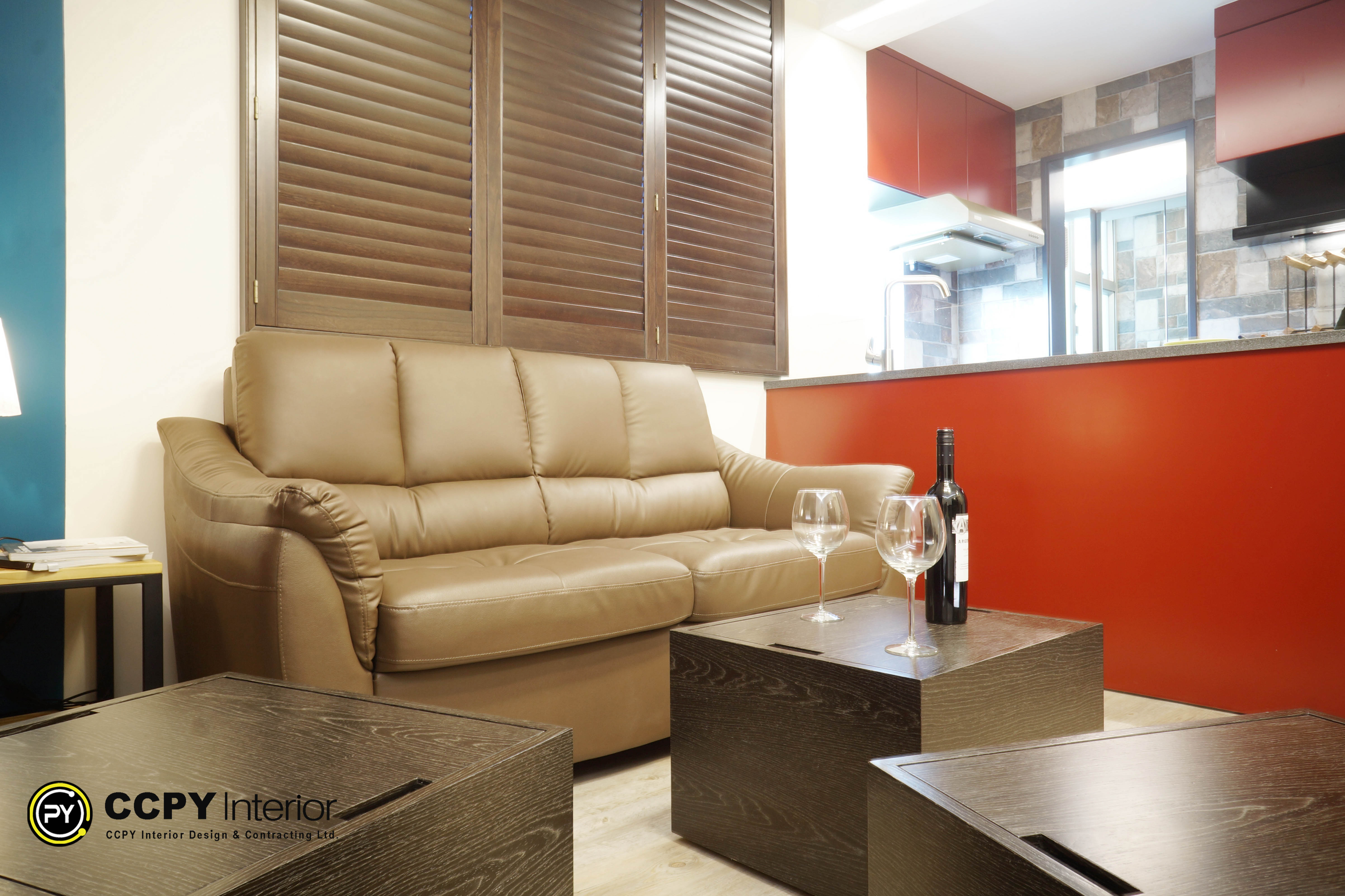 Kitchen & Dining Integration: Uses a half-wall counter space with bold red accents to divide the living room from a functional open-kitchen area, creating a highly polished, fashion-forward aesthetic.