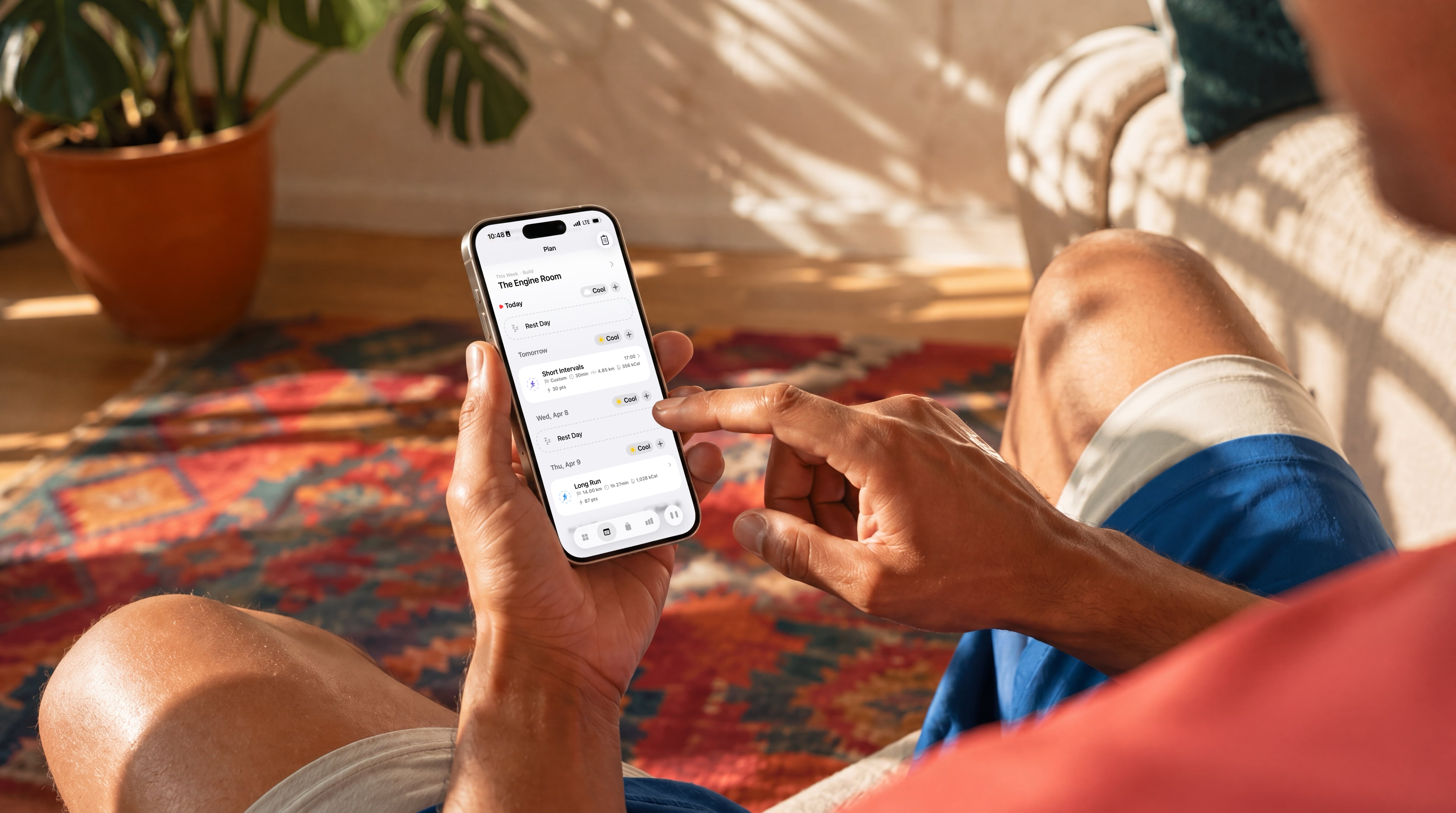 Image showing a man, in bed, phone in hand, peaks morning sleep summary open