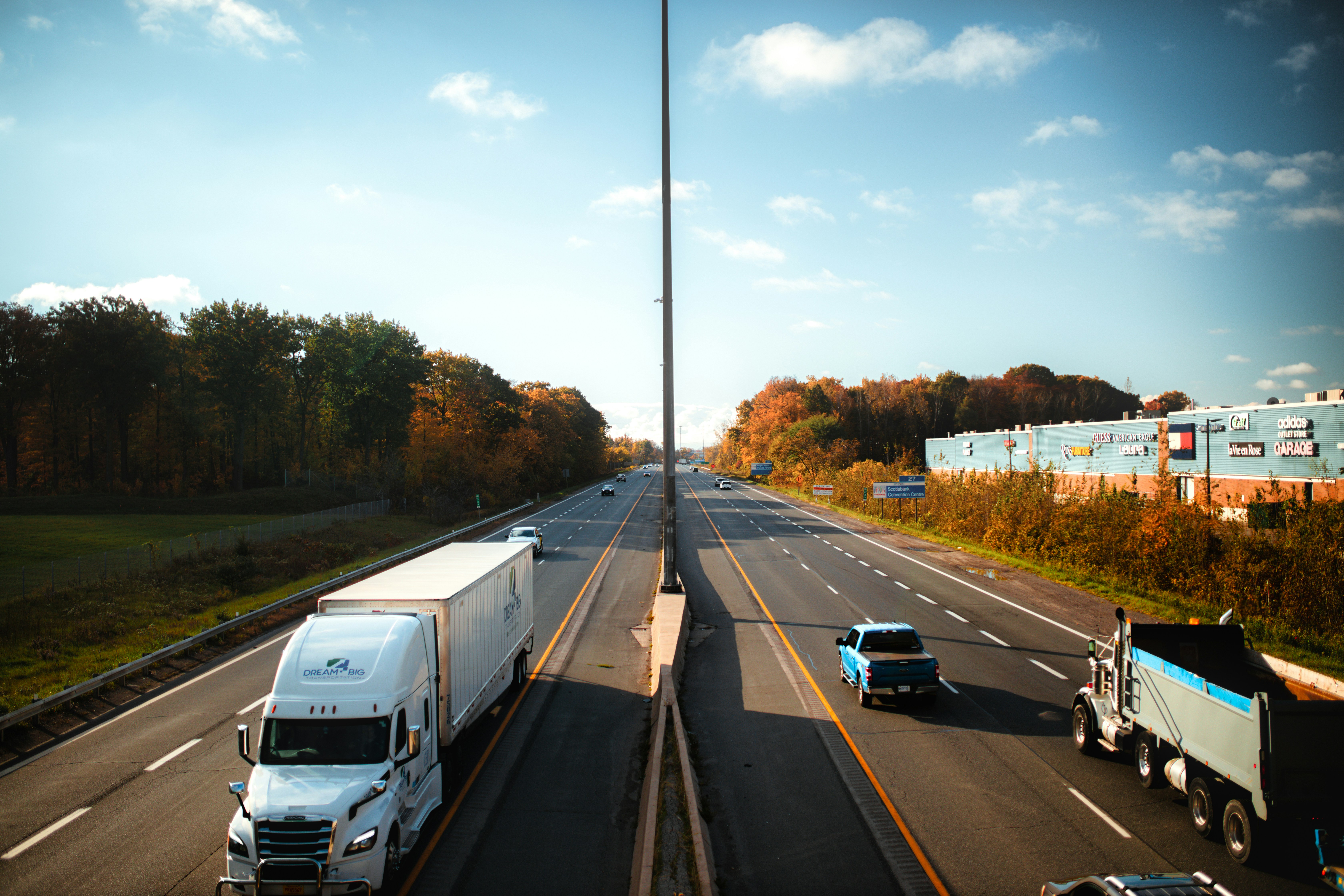 Truck and cars on a road with a sunset