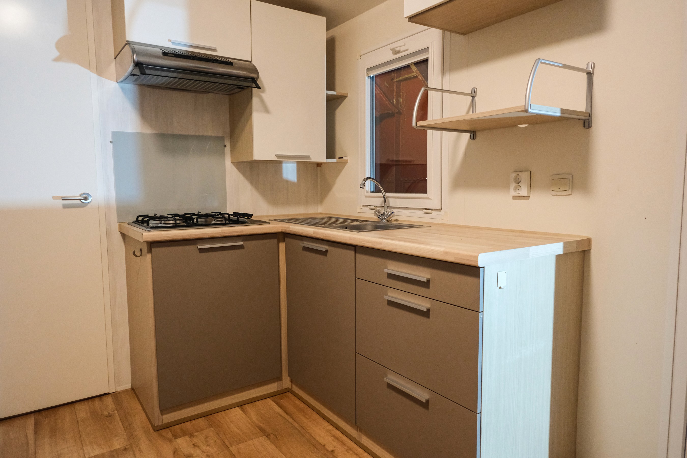Gray sectional sofa with black coffee table and blue rug