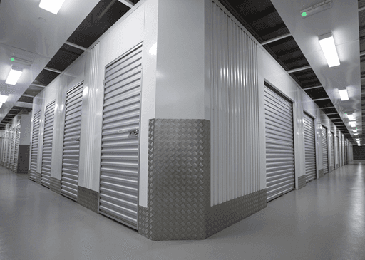 Clean hallway with roll-up doors at modern facility providing premium car storage solutions.