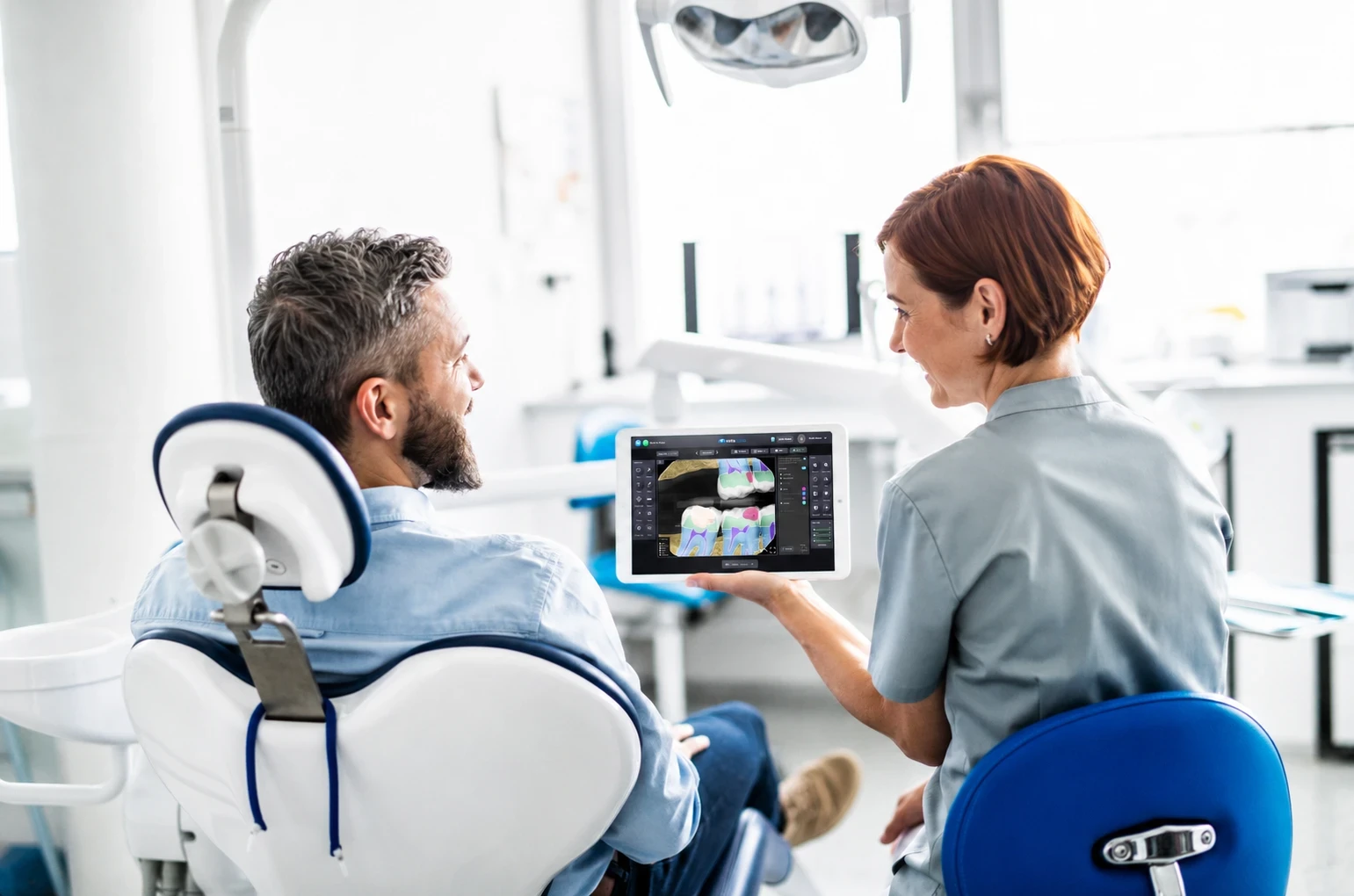 Dentist and patient talking while looking at SOTA Cloud software