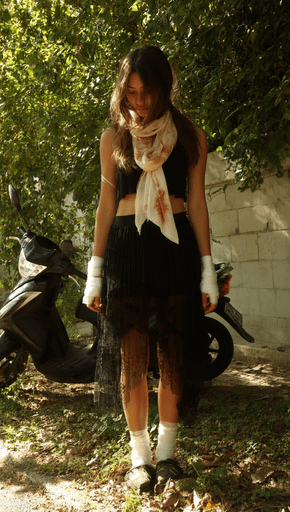 Girl in Thailand next to a Scooter after an accident