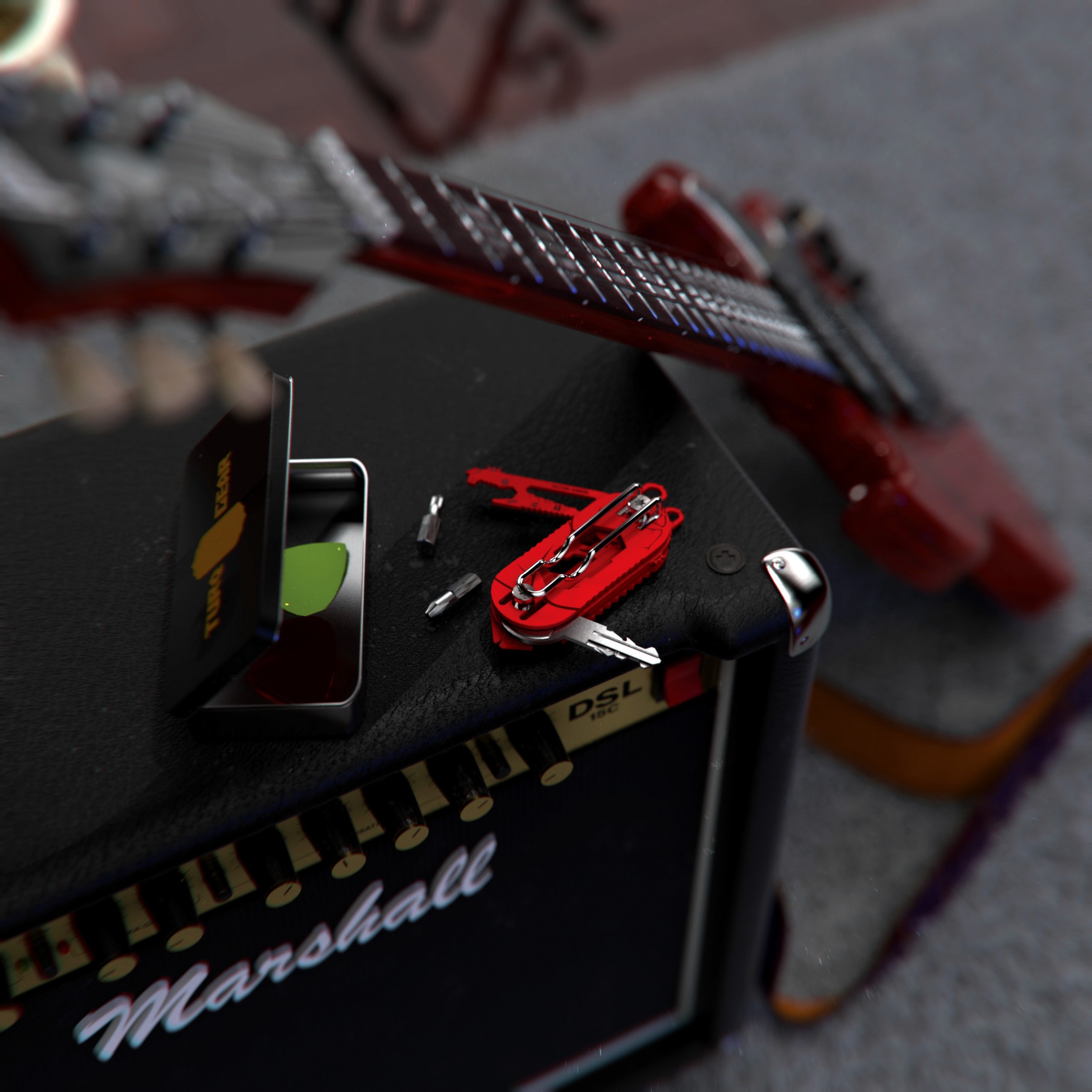 Lifestyle product photography of the red Turq Gear 'Plankton' multi-tool placed on a guitar amplifier. Highlights the product's compact design and utility in a creative, everyday setting, reinforcing the brand's connection to modern lifestyle and functionality.