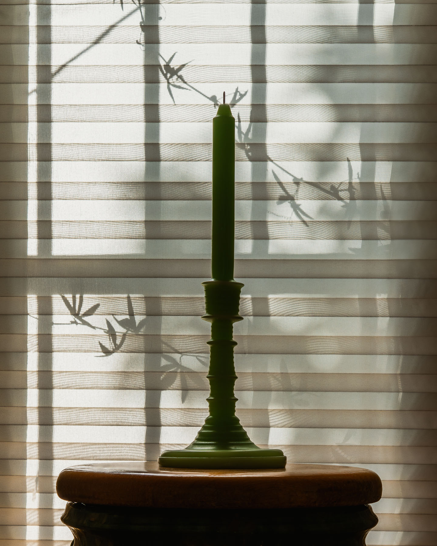 Cucumber LOEWE Wax Scented Candleholder placed by a window with soft summer light filtering through.