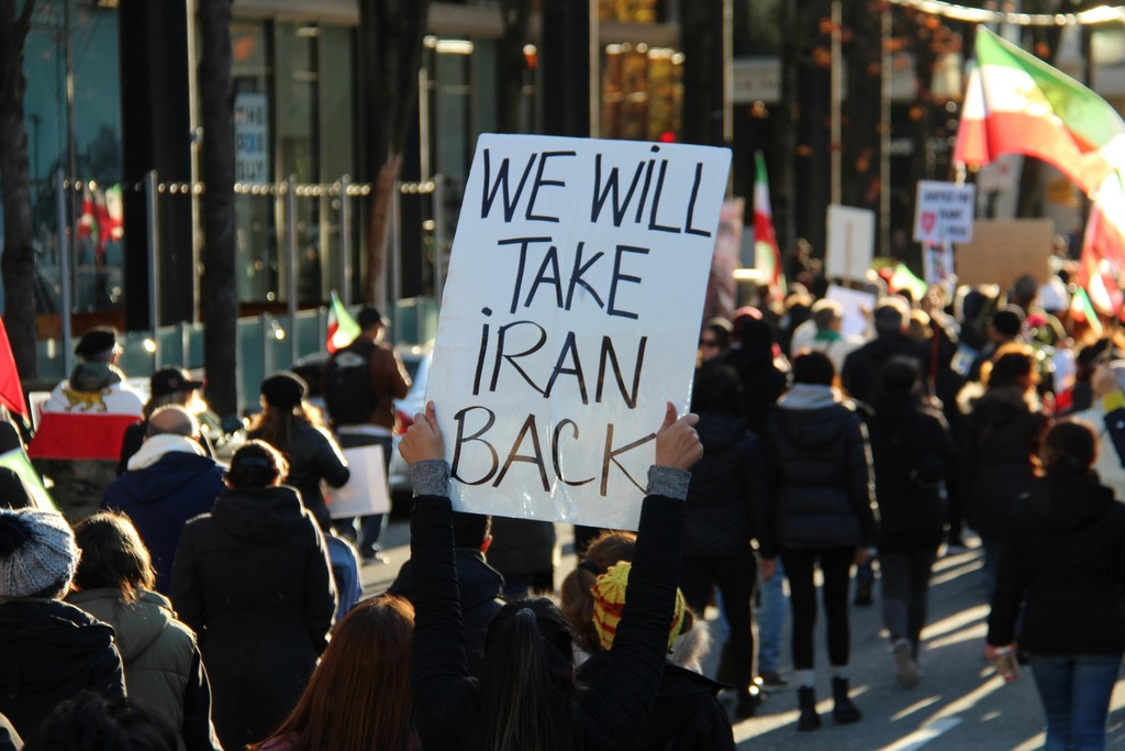 Crowd demonstrating amid geopolitical tensions and economic uncertainty