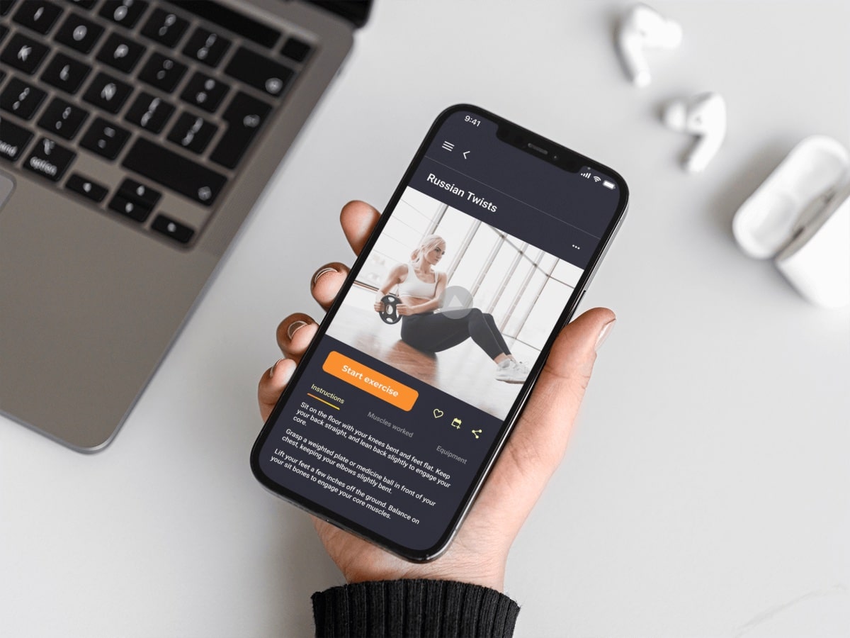 Mockup image of a user's hand holding a mobile phone, showing hi-fidelity wireframe