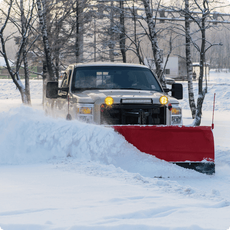 Truck with snow plow pushing snow