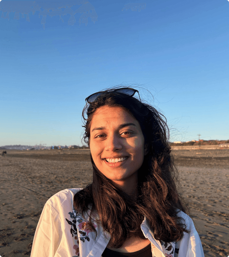 A thoughtful young person with dark hair gazes to the side, captured in soft black and white lighting.