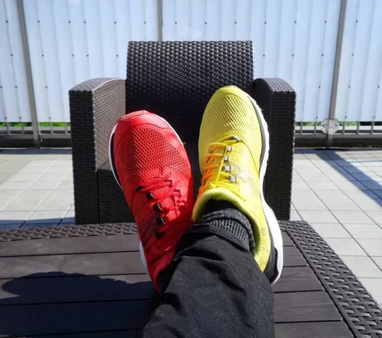 a  pair of legs crossed on top of each other, one foot wearing a red shoe and the other wearing a yellow shoe, showcasing the difference between a story and an anecdote

