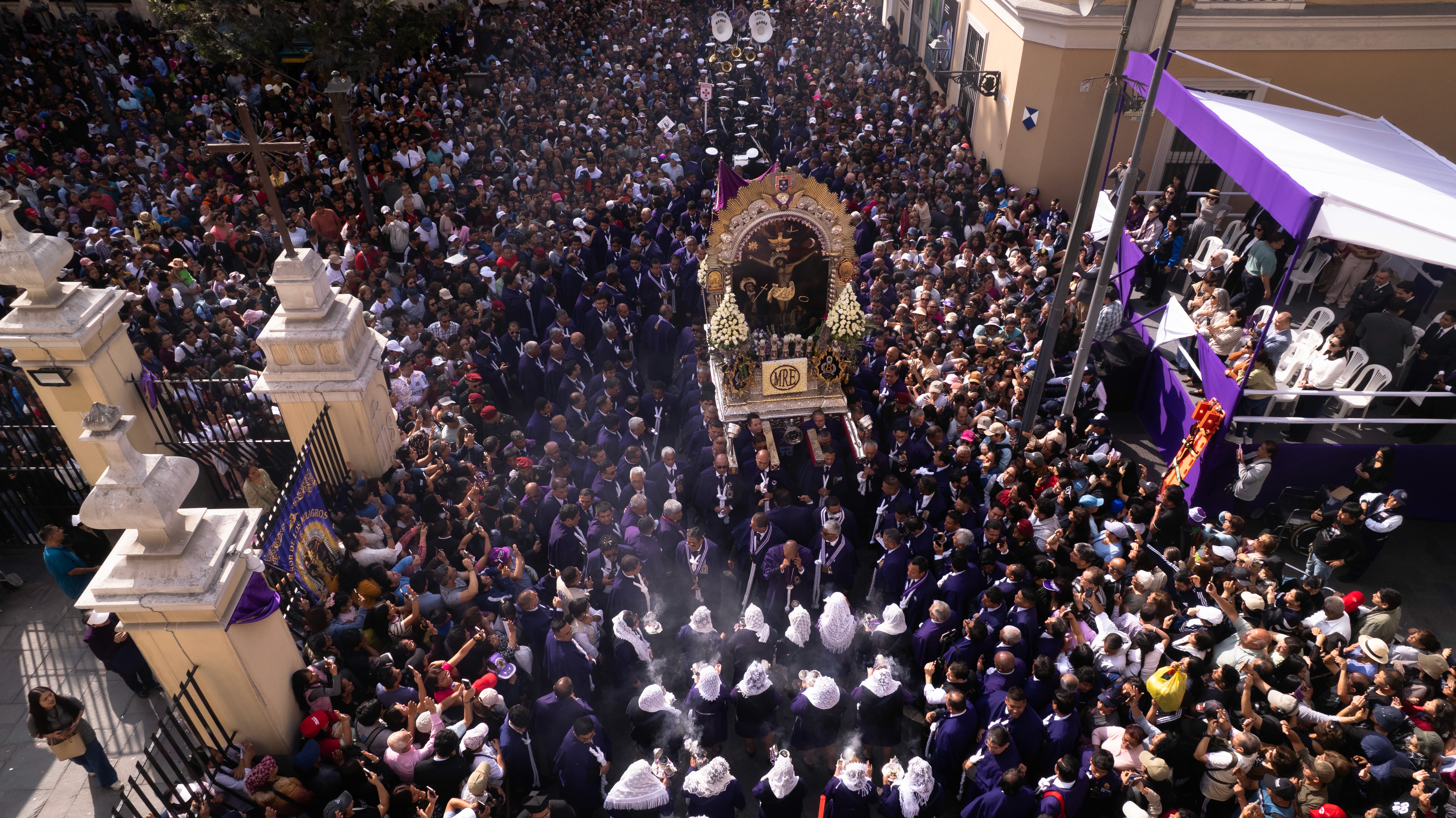 Devotees carry the image of Señor de los Milagros through the streets of Lima, Peru.