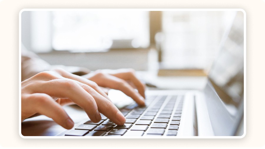 hands typing on a laptop