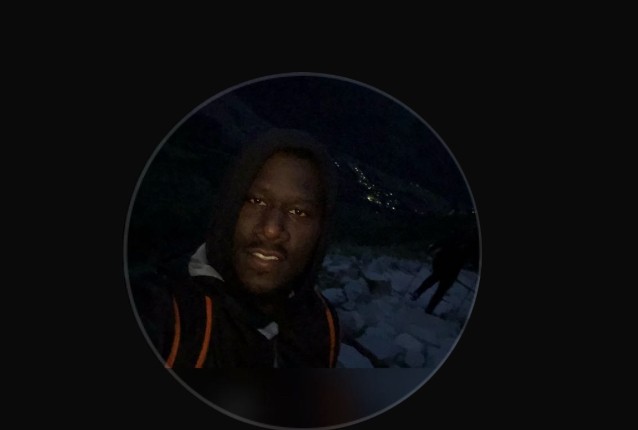 Young woman with long brown hair outdoors.