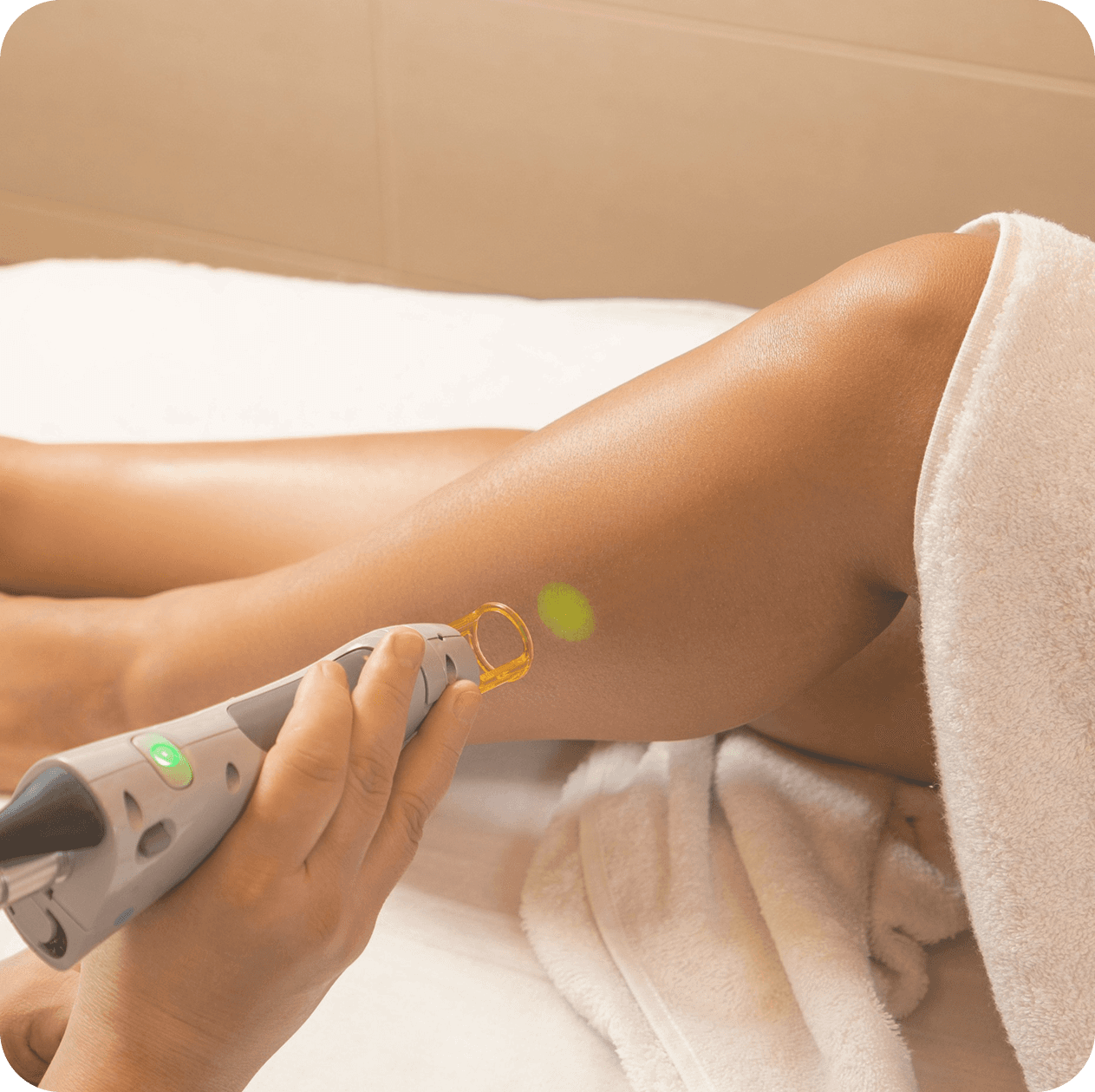 Woman relaxing on a massage table with candles in the background, receiving a back massage in a spa setting