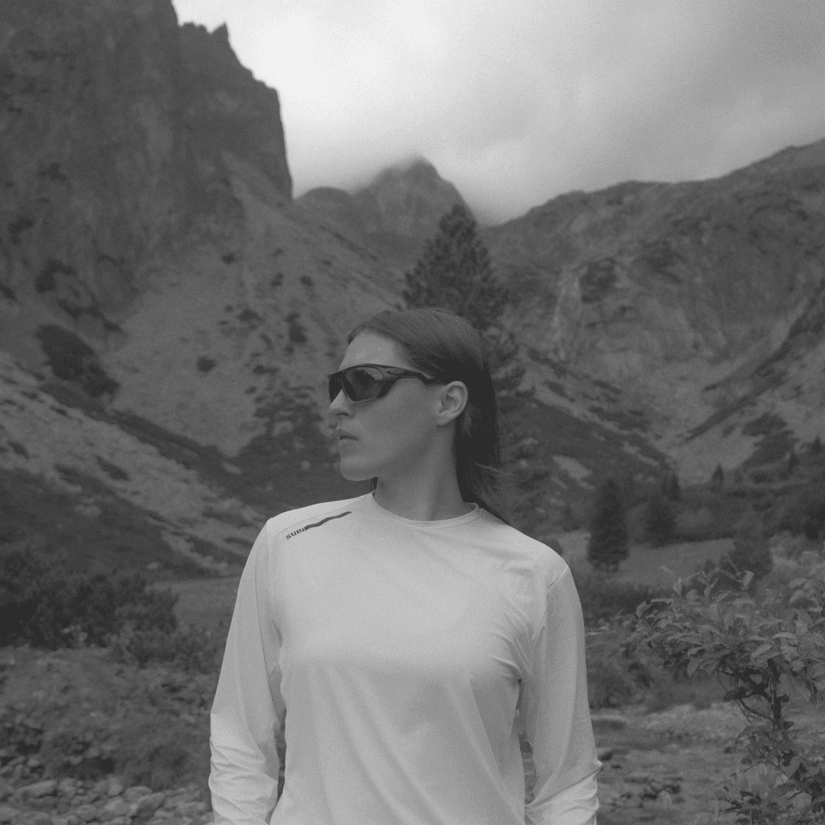 black and white picture of a woman wearing running glasses.