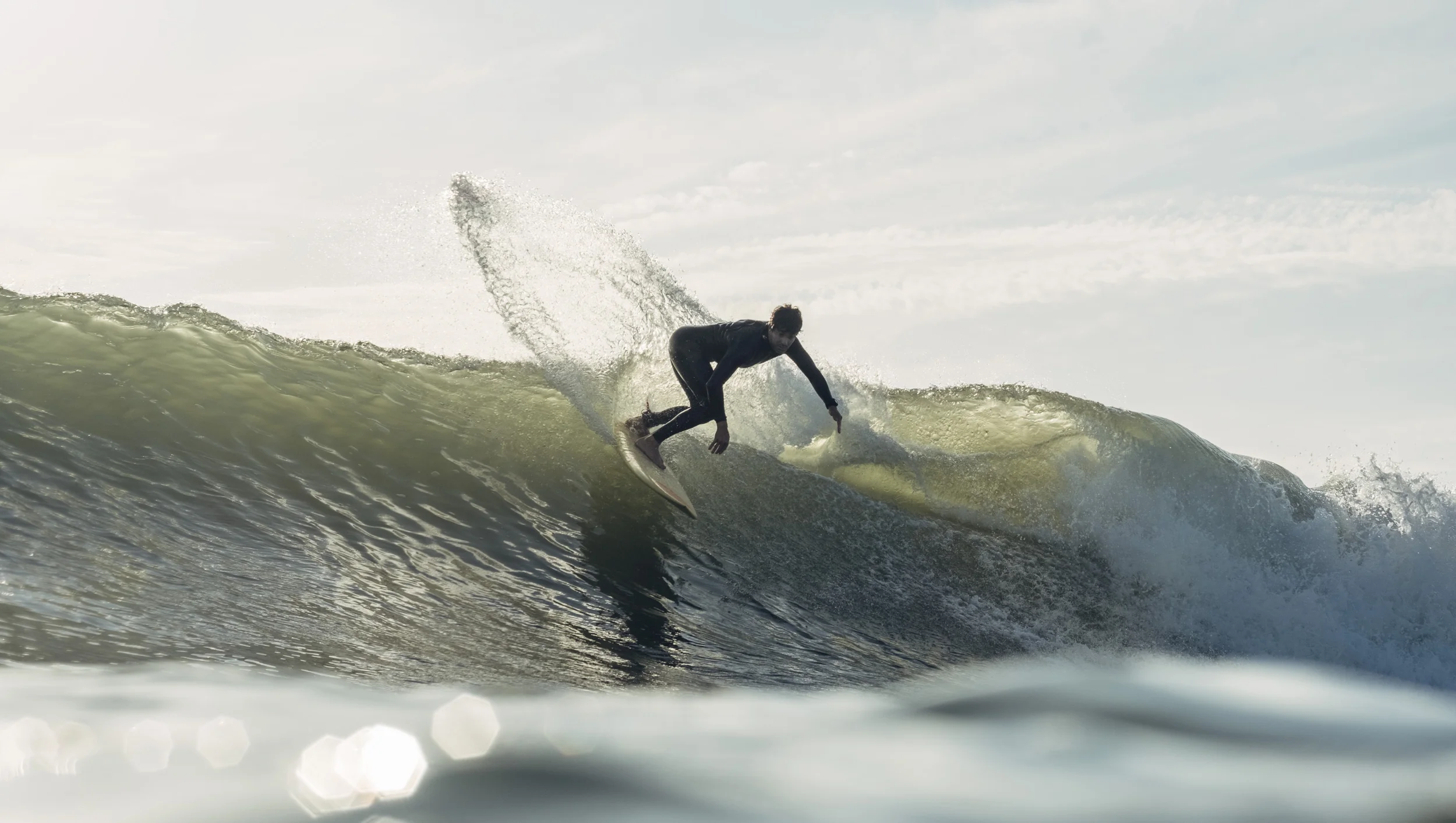 a man riding a wave on top of a surfboard